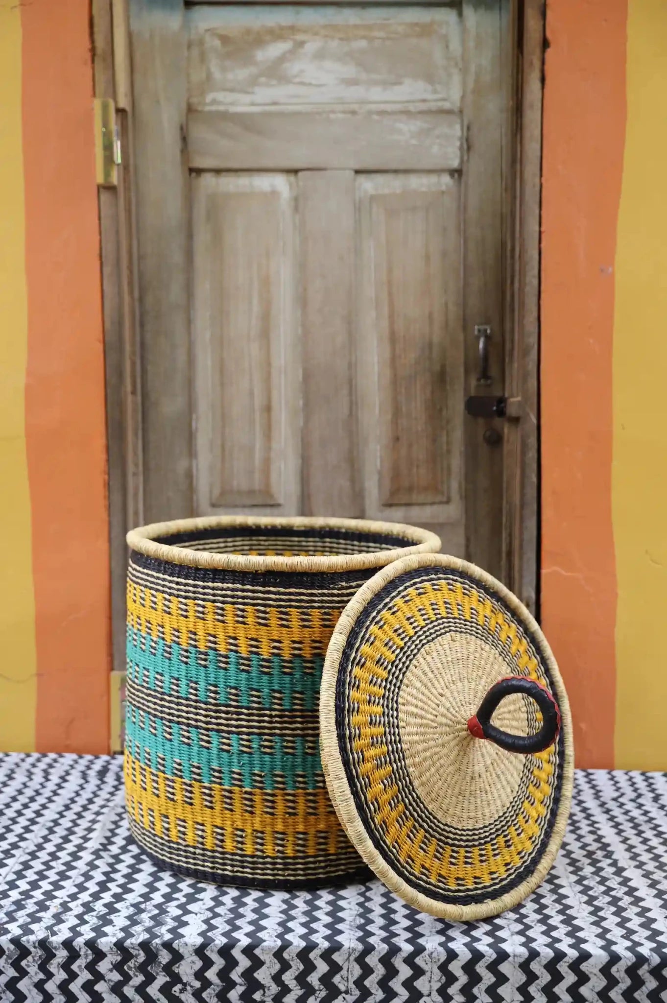 Lidded Laundry Basket with coil (Large) by The Baba Tree. Handwoven elephant grass with leather handle. Premium Bolgatanga artisan decor.