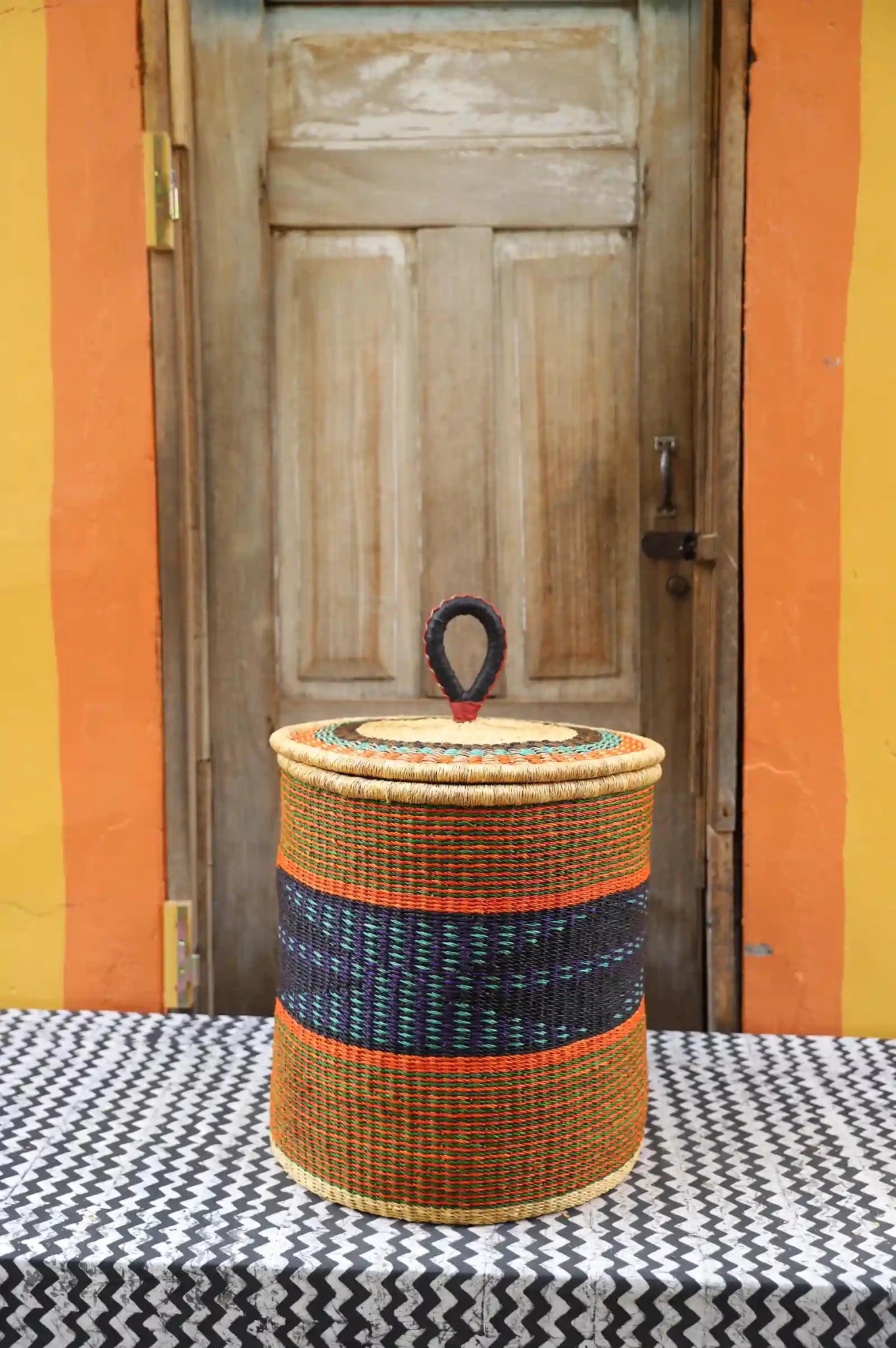 Lidded Laundry Basket with coil (Medium) by The Baba Tree. Handwoven elephant grass with leather handle. Premium Bolgatanga artisan decor.