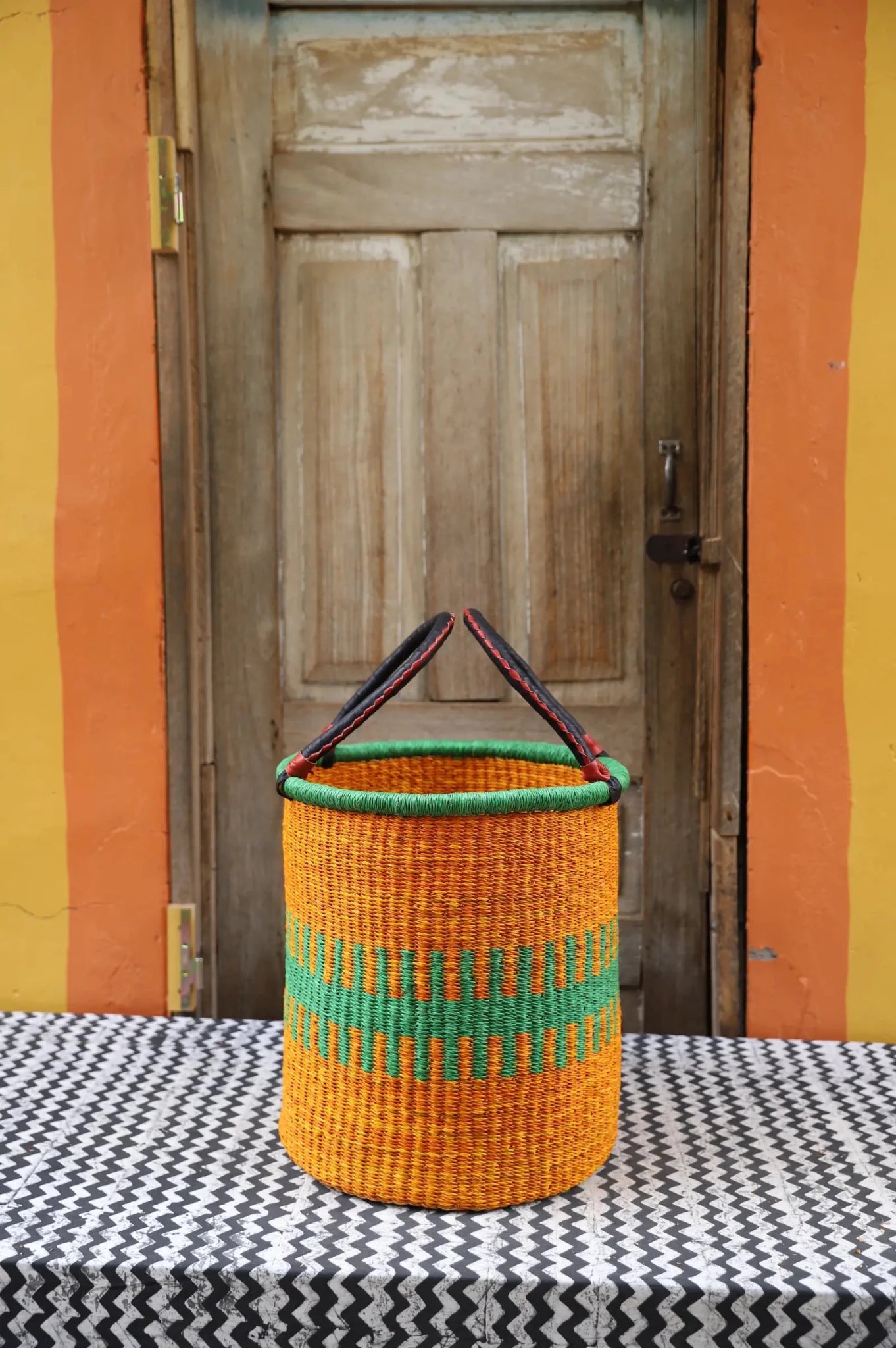 Open Laundry Basket (Small) by The Baba Tree. Handwoven elephant grass storage with leather handles. Bolgatanga artisan decor.