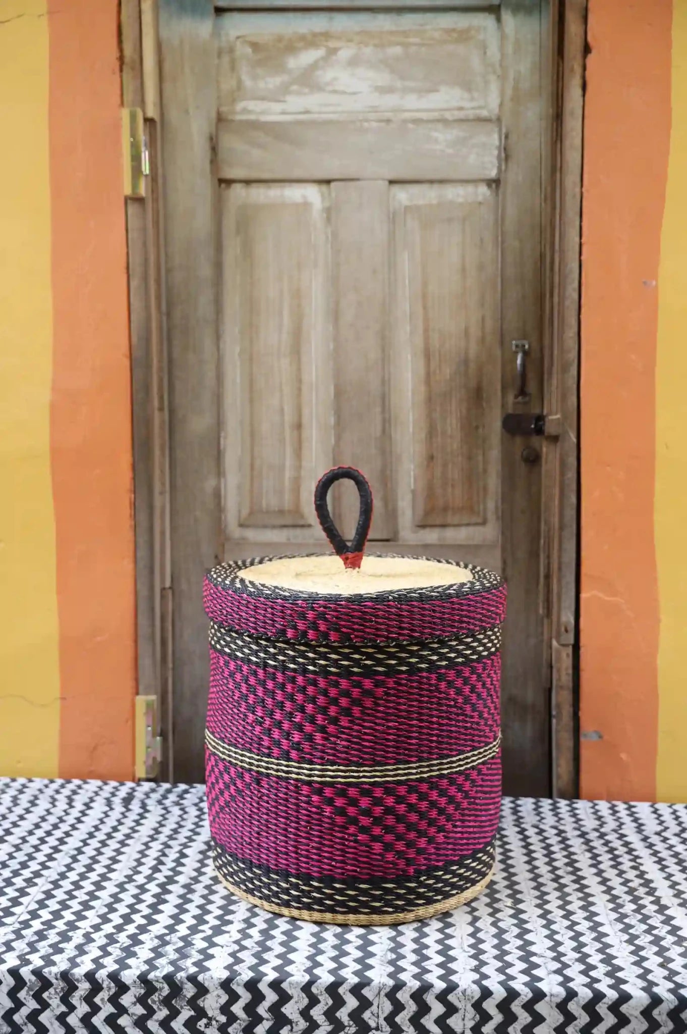 Lidded Laundry Basket (Medium) by The Baba Tree. Handwoven elephant grass with leather handle. Premium Bolgatanga artisan decor.l