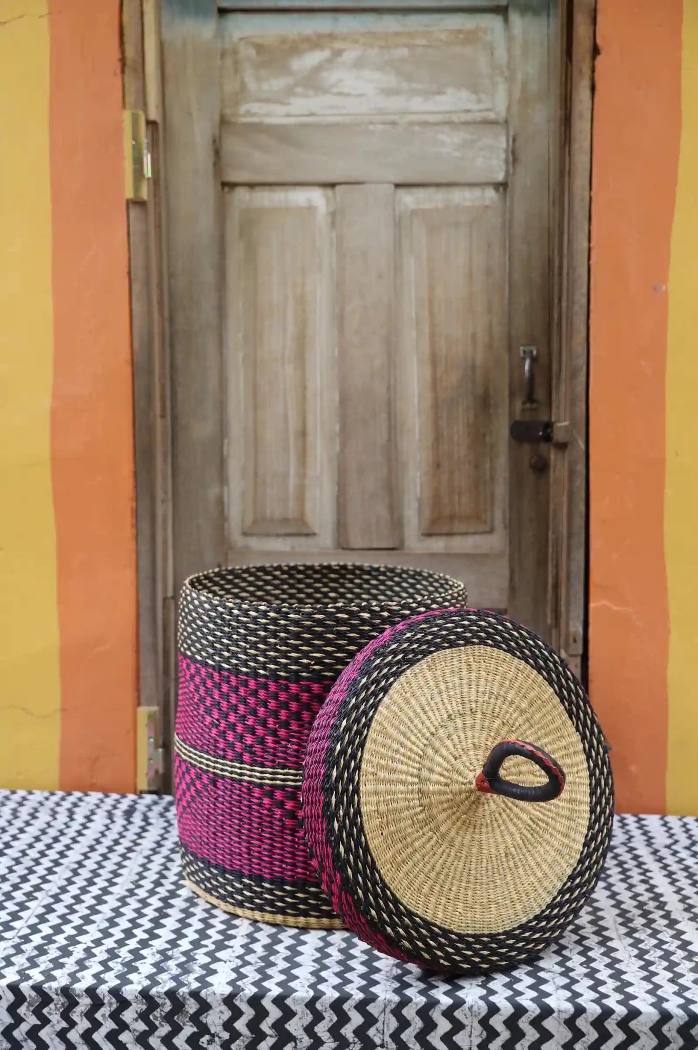 Lidded Laundry Basket (Medium) by The Baba Tree. Handwoven elephant grass with leather handle. Premium Bolgatanga artisan decor.l