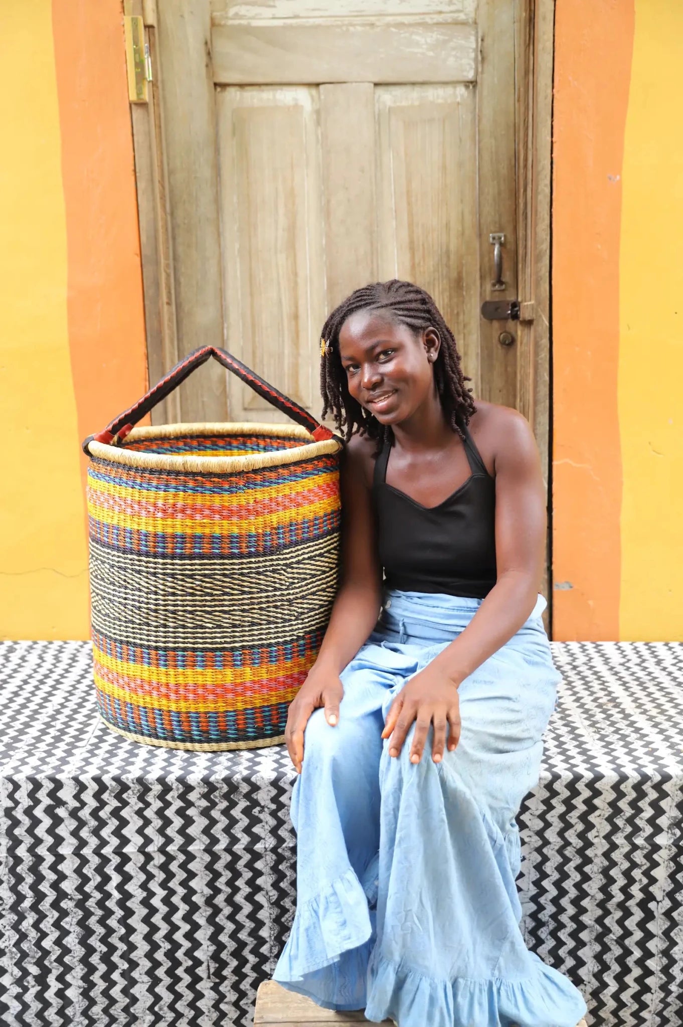 Open Laundry Basket (Large) by The Baba Tree. Handwoven elephant grass storage with leather handles. Bolgatanga artisan decor.
