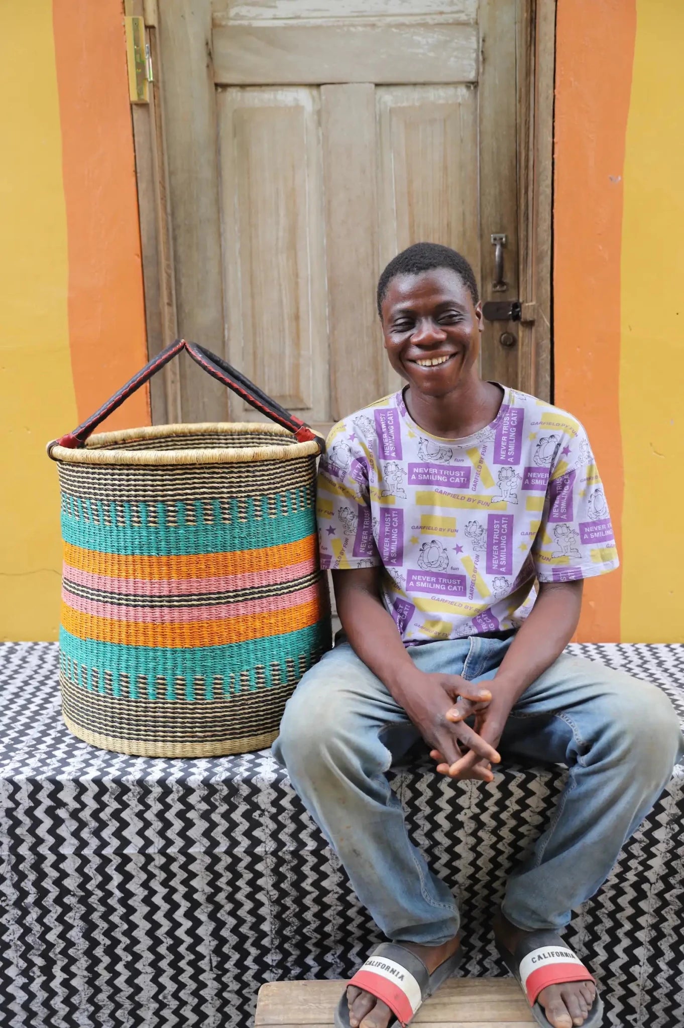 Open Laundry Basket (Large) by The Baba Tree. Handwoven elephant grass storage with leather handles. Bolgatanga artisan decor.
