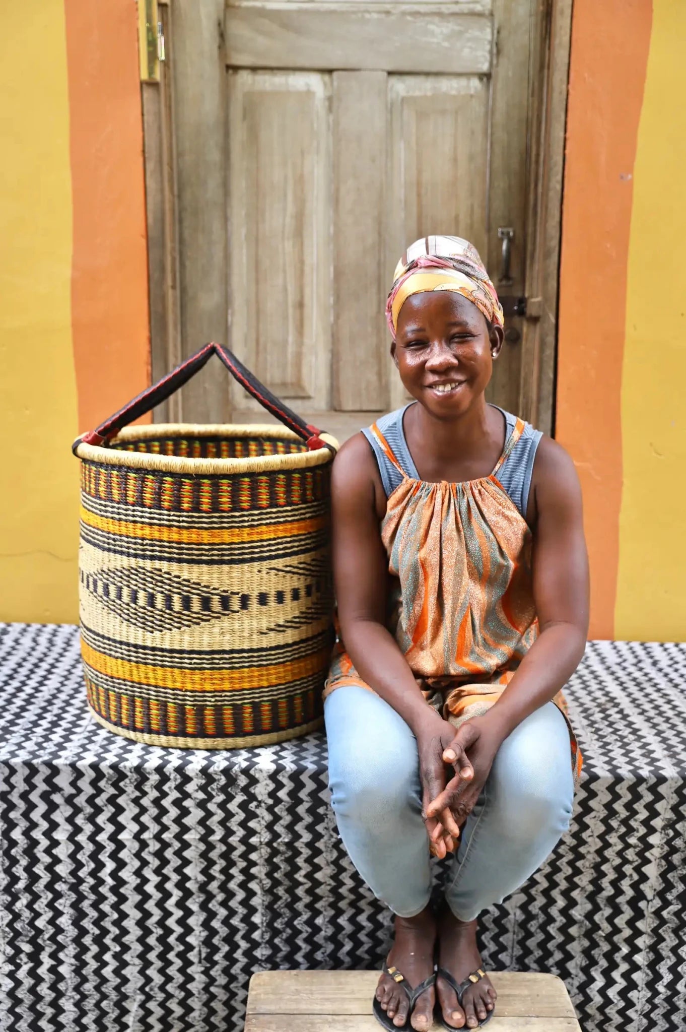 Open Laundry Basket (Medium) by The Baba Tree. Handwoven elephant grass storage with leather handles. Bolgatanga artisan decor.