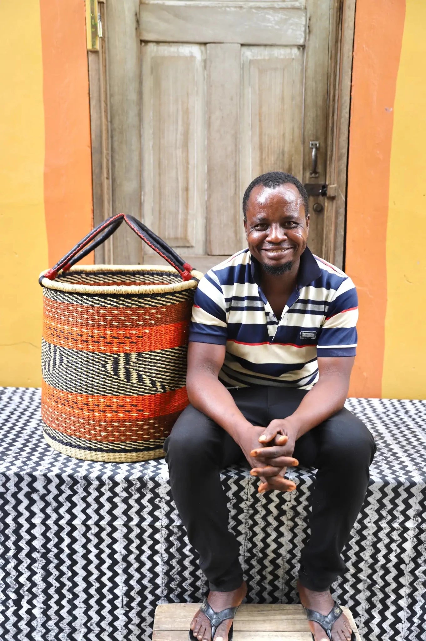 Open Laundry Basket (Medium) by The Baba Tree. Handwoven elephant grass storage with leather handles. Bolgatanga artisan decor.