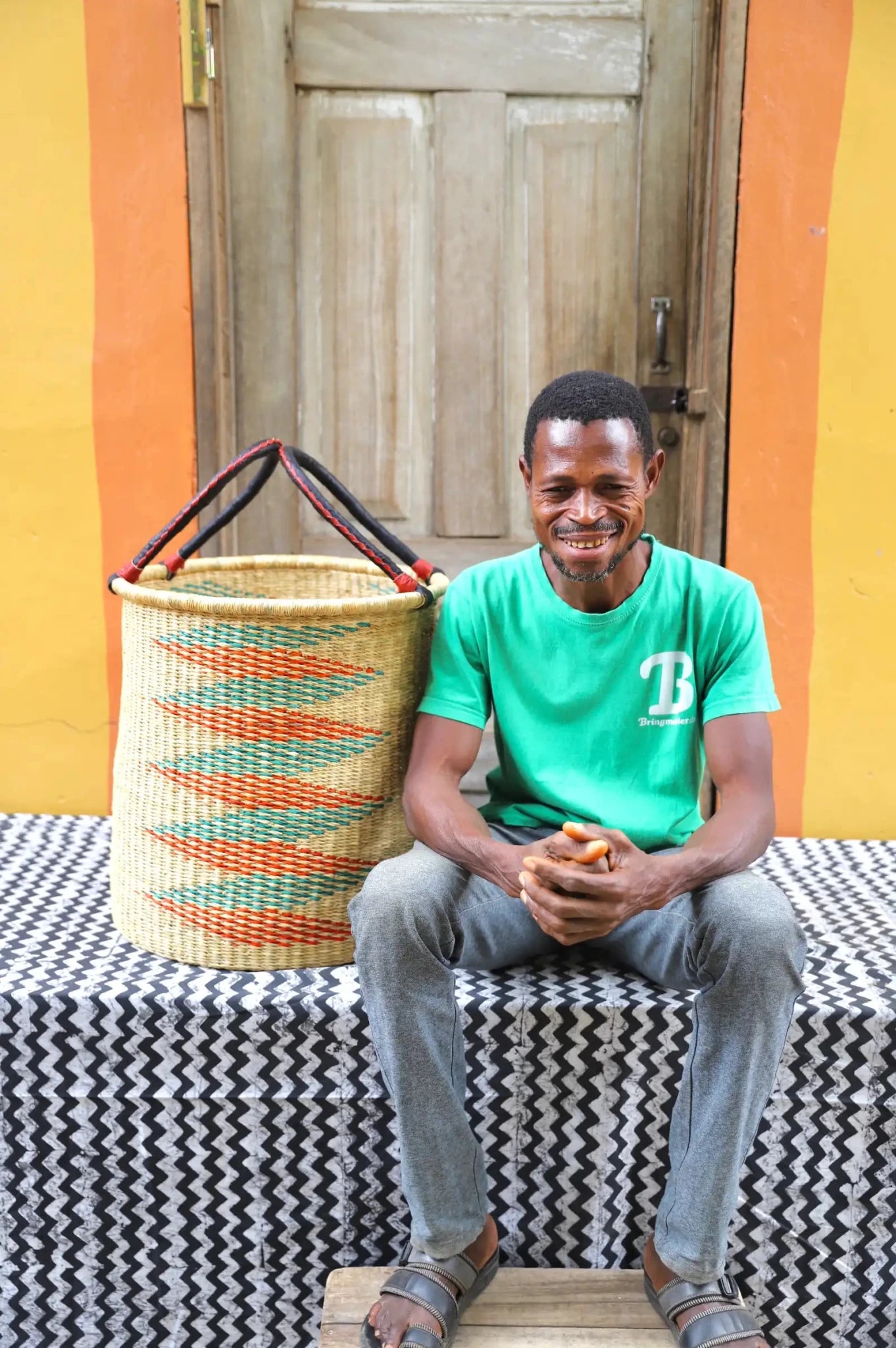 Open Laundry Basket (Medium) by The Baba Tree. Handwoven elephant grass storage with leather handles. Bolgatanga artisan decor.