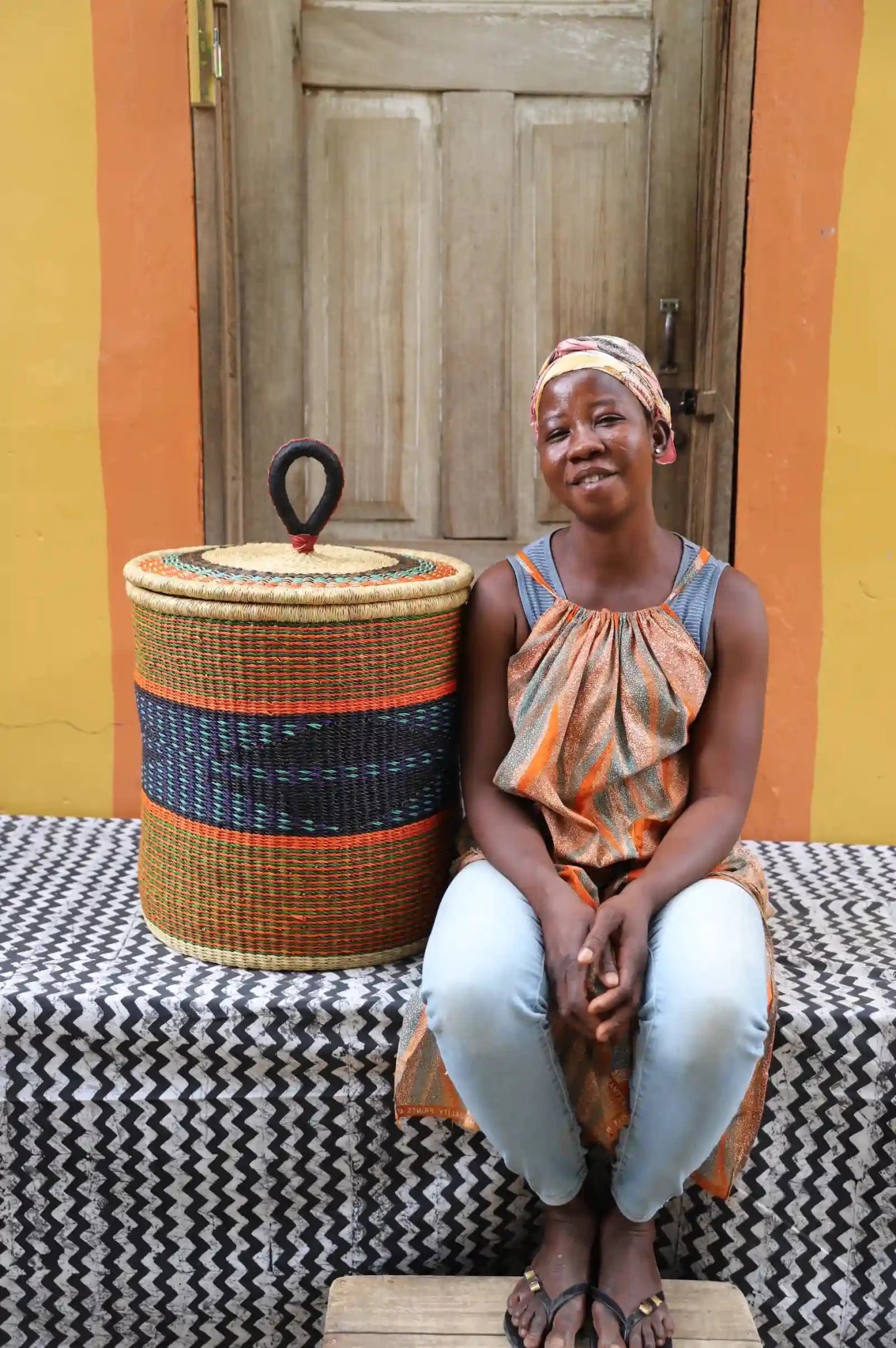 Lidded Laundry Basket with coil (Medium) by The Baba Tree. Handwoven elephant grass with leather handle. Premium Bolgatanga artisan decor.