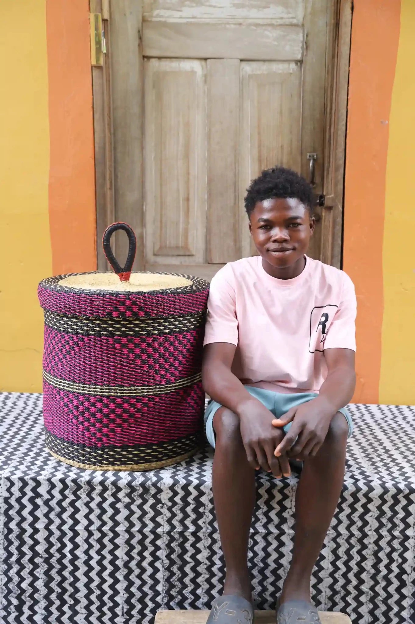Lidded Laundry Basket (Medium) by The Baba Tree. Handwoven elephant grass with leather handle. Premium Bolgatanga artisan decor.l