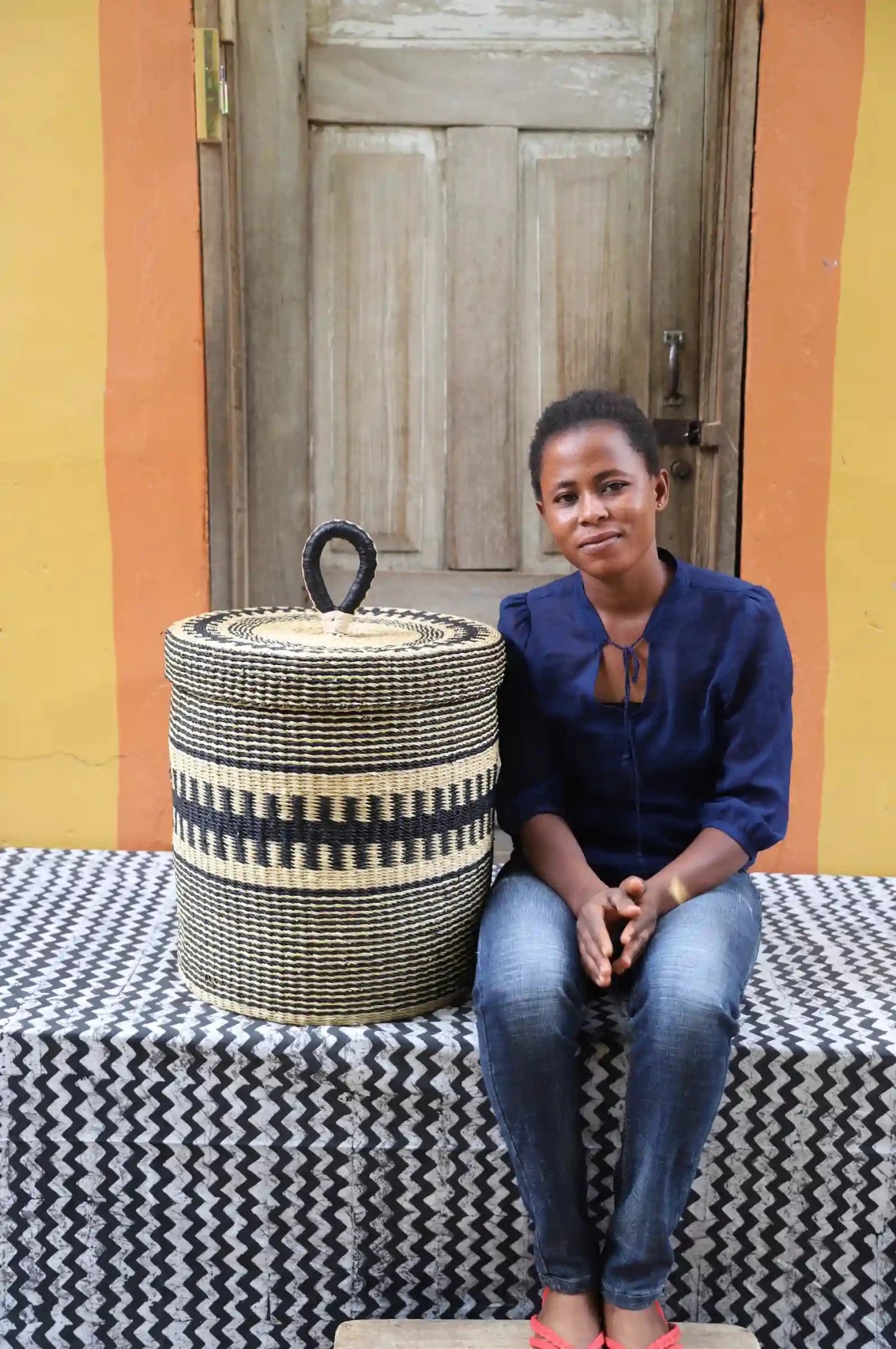 Lidded Laundry Basket  (Small) by The Baba Tree. Handwoven elephant grass
with leather handle. Premium Bolgatanga artisan decor.