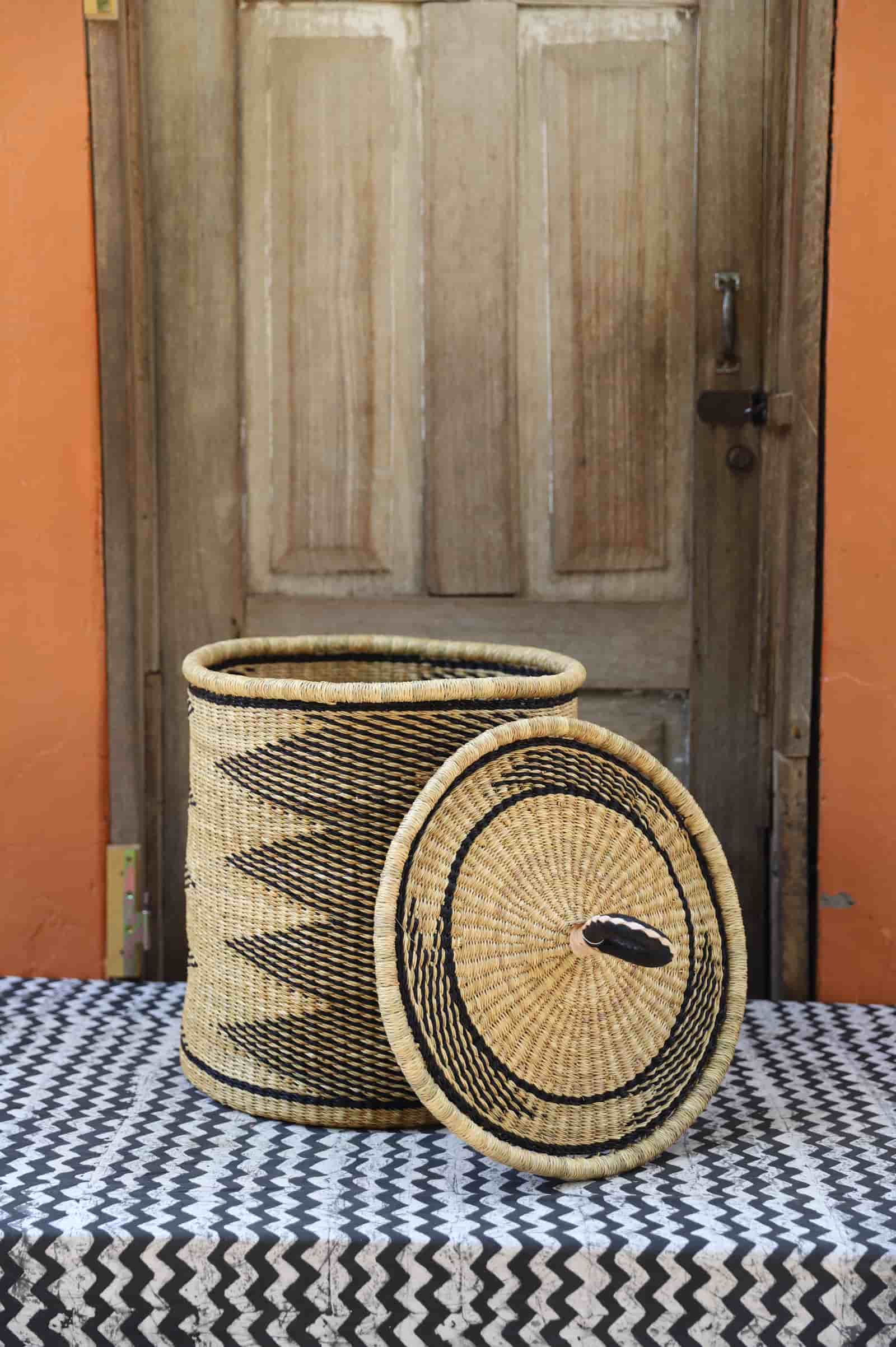 Lidded Laundry Basket with coil (Small) by The Baba Tree. Handwoven elephant grass with leather handle. Premium Bolgatanga artisan decor.