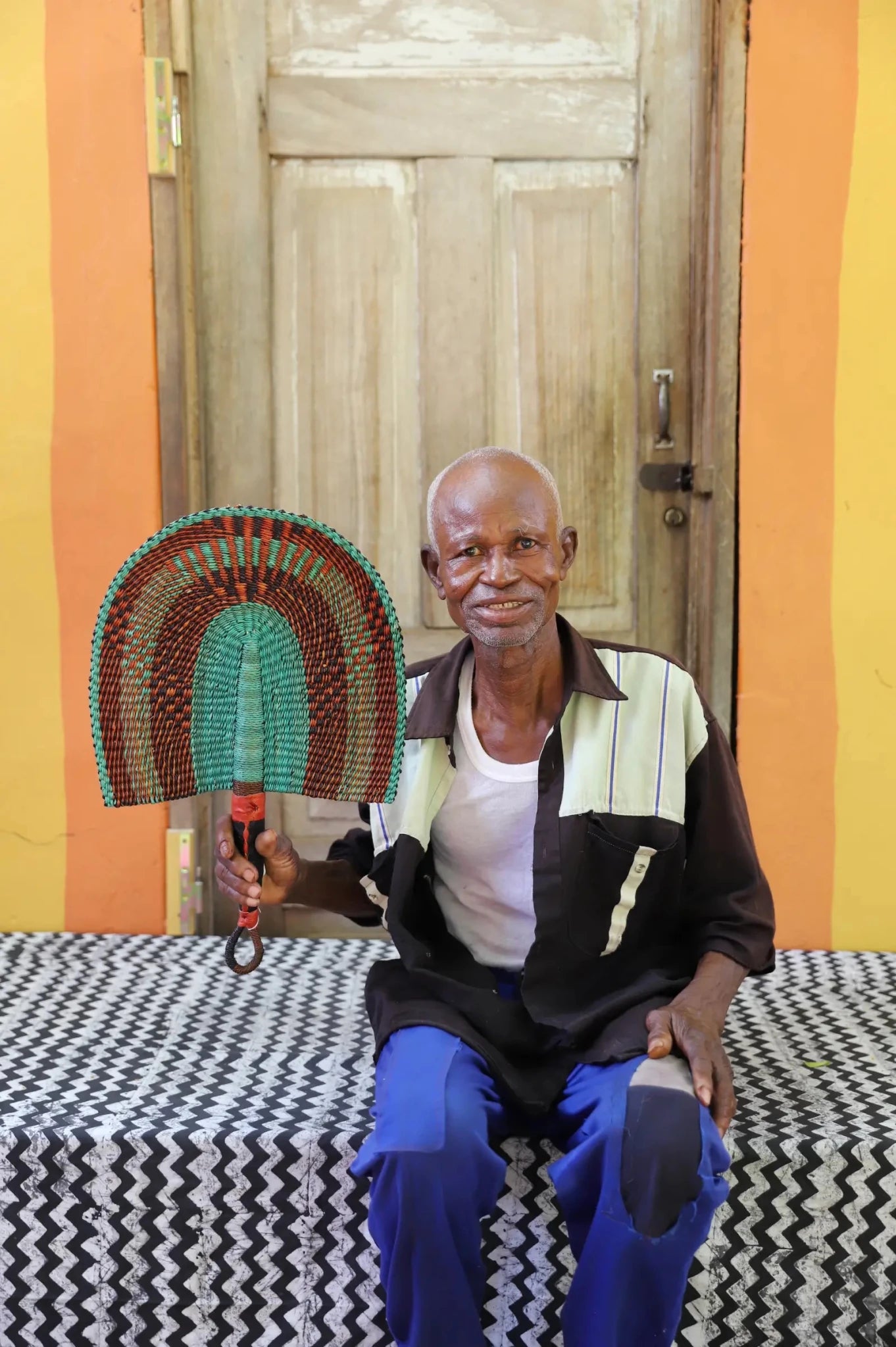 The Baba Tree Bolga Original Fan: Handwoven architectural wall art with intricate weave and premium leather handle. 