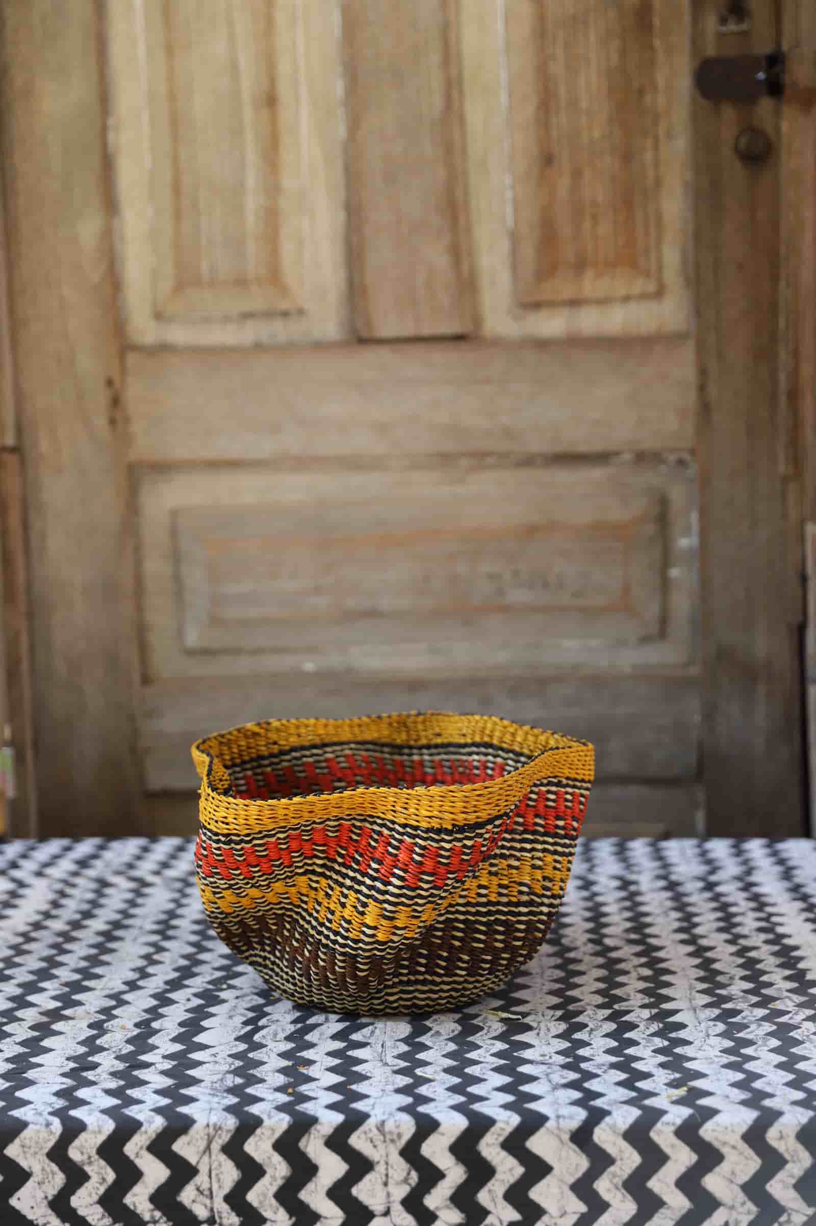 Tiny Pakurigo Wave Décor Basket with amber and rust wave-stripe pattern on dark ground