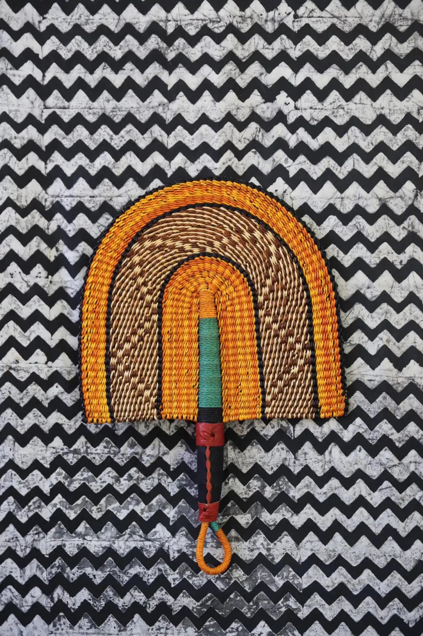 The Baba Tree Bolga Original Fan: Handwoven architectural wall art with intricate weave and premium leather handle. 
