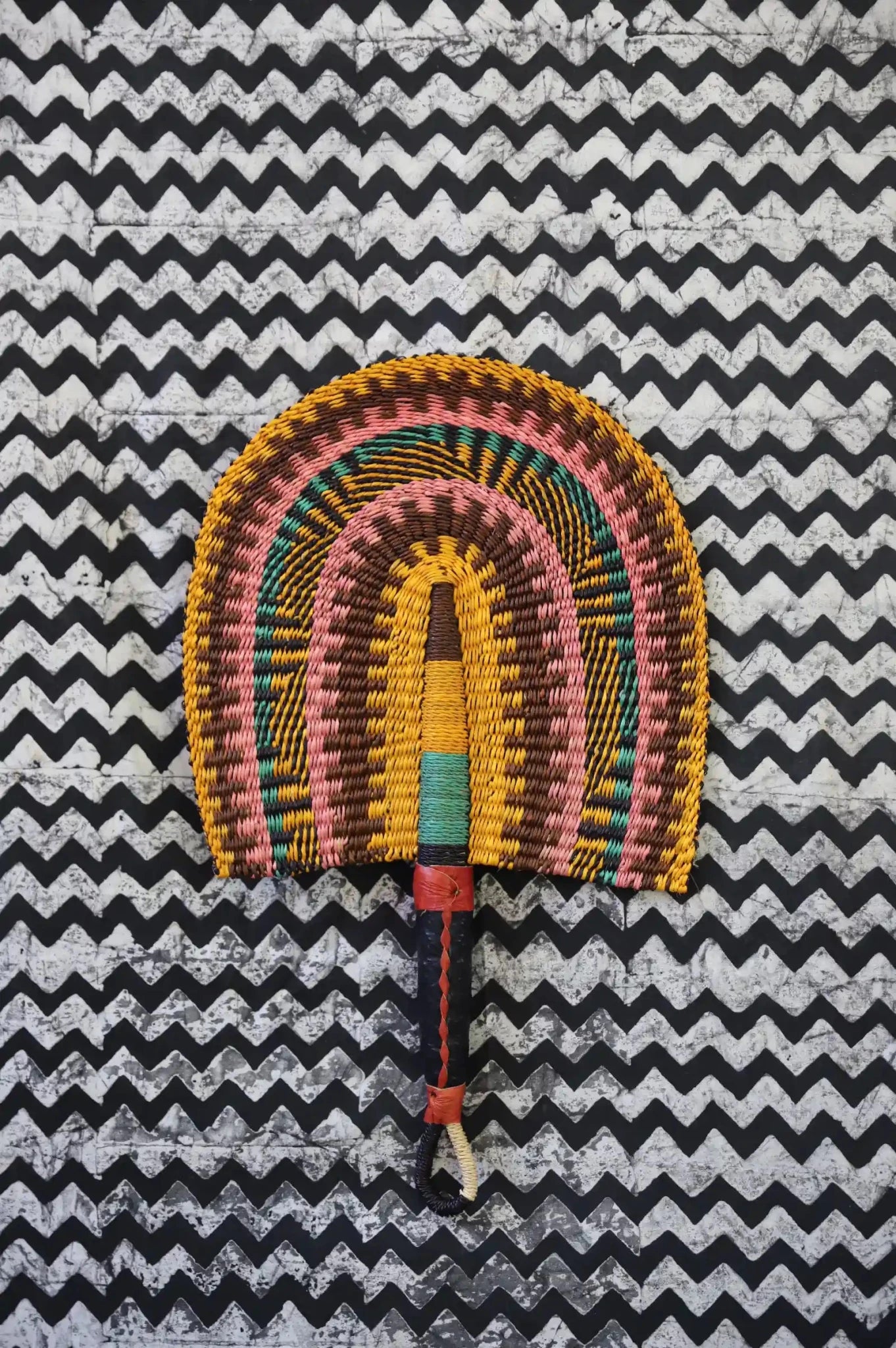 The Baba Tree Bolga Original Fan: Handwoven architectural wall art with intricate weave and premium leather handle. 
