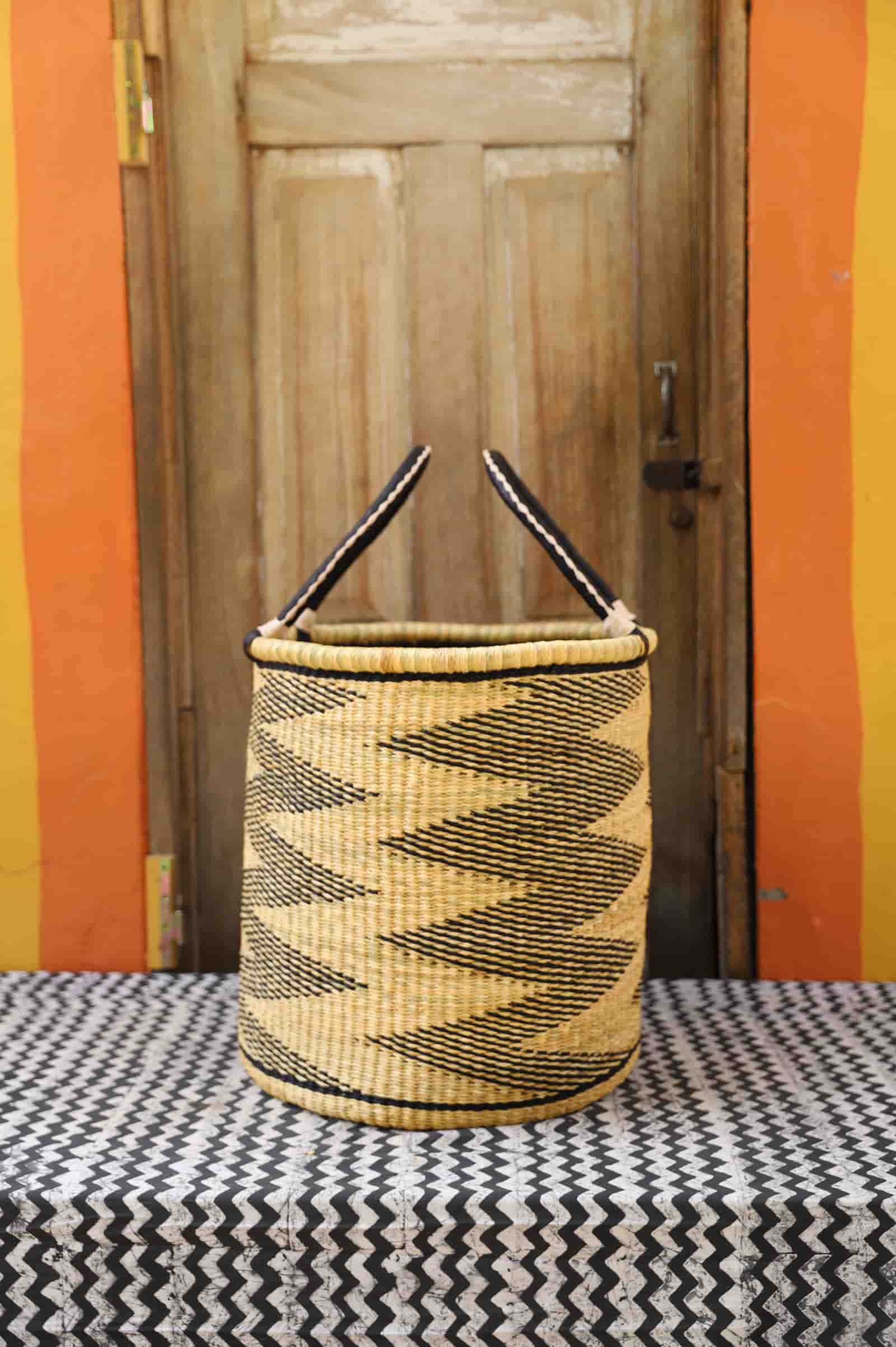 Open Laundry Basket (Large) by The Baba Tree. Handwoven elephant grass storage with leather handles. Bolgatanga artisan decor.