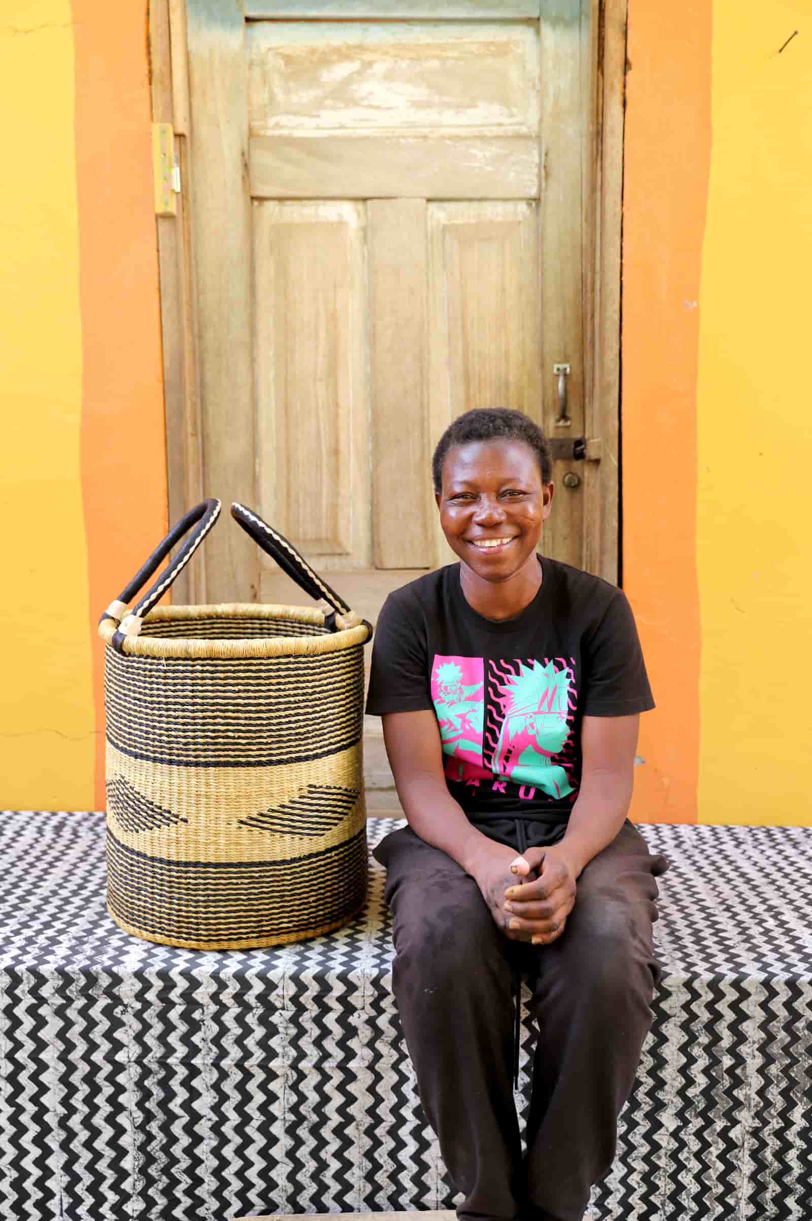 Open Laundry Basket by The Baba Tree. Handwoven elephant grass storage with leather handles. Bolgatanga artisan decor.
