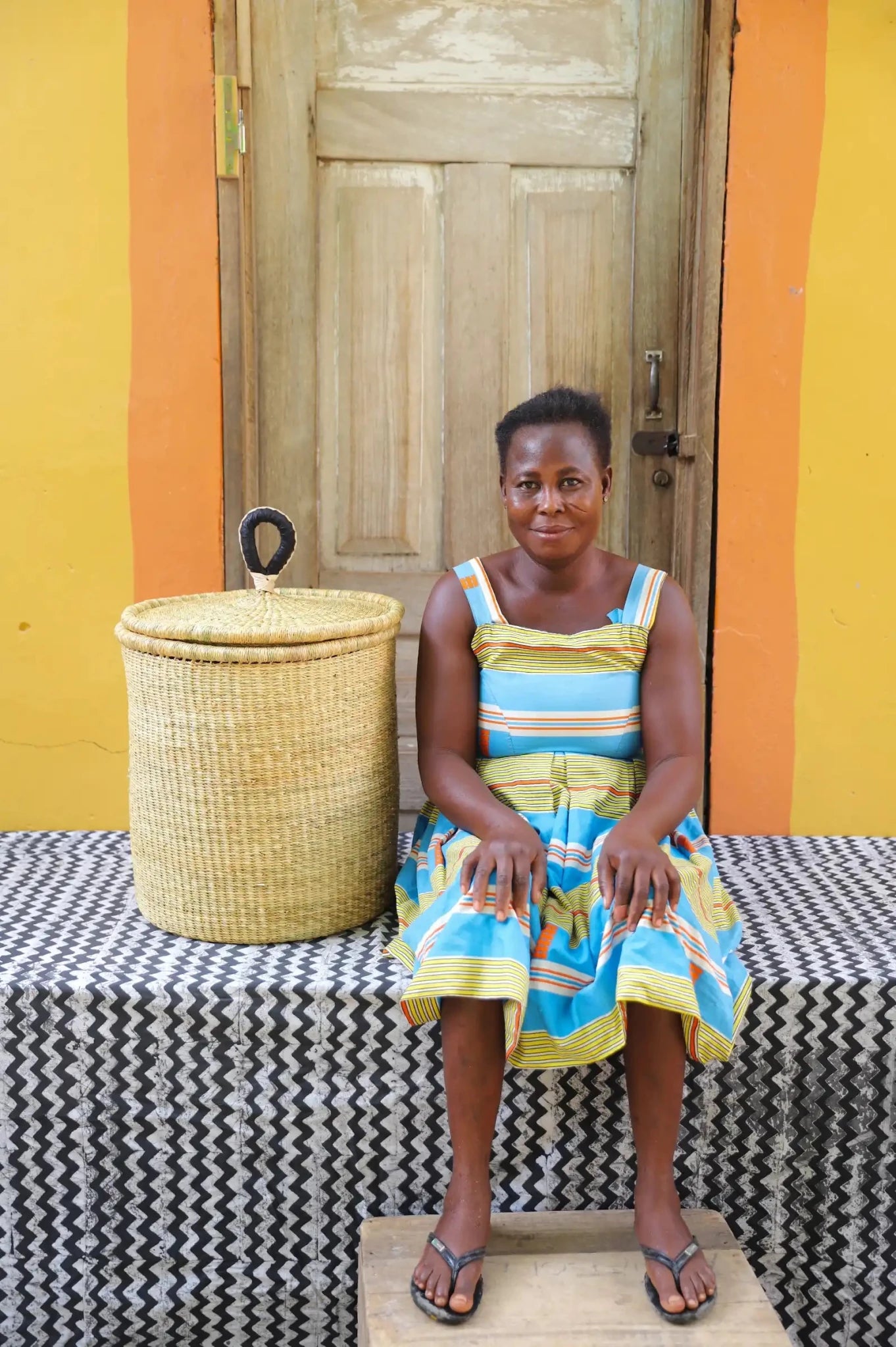 Lidded Laundry Basket with coil (Small) by The Baba Tree. Handwoven elephant grass with leather handle. Premium Bolgatanga artisan decor.