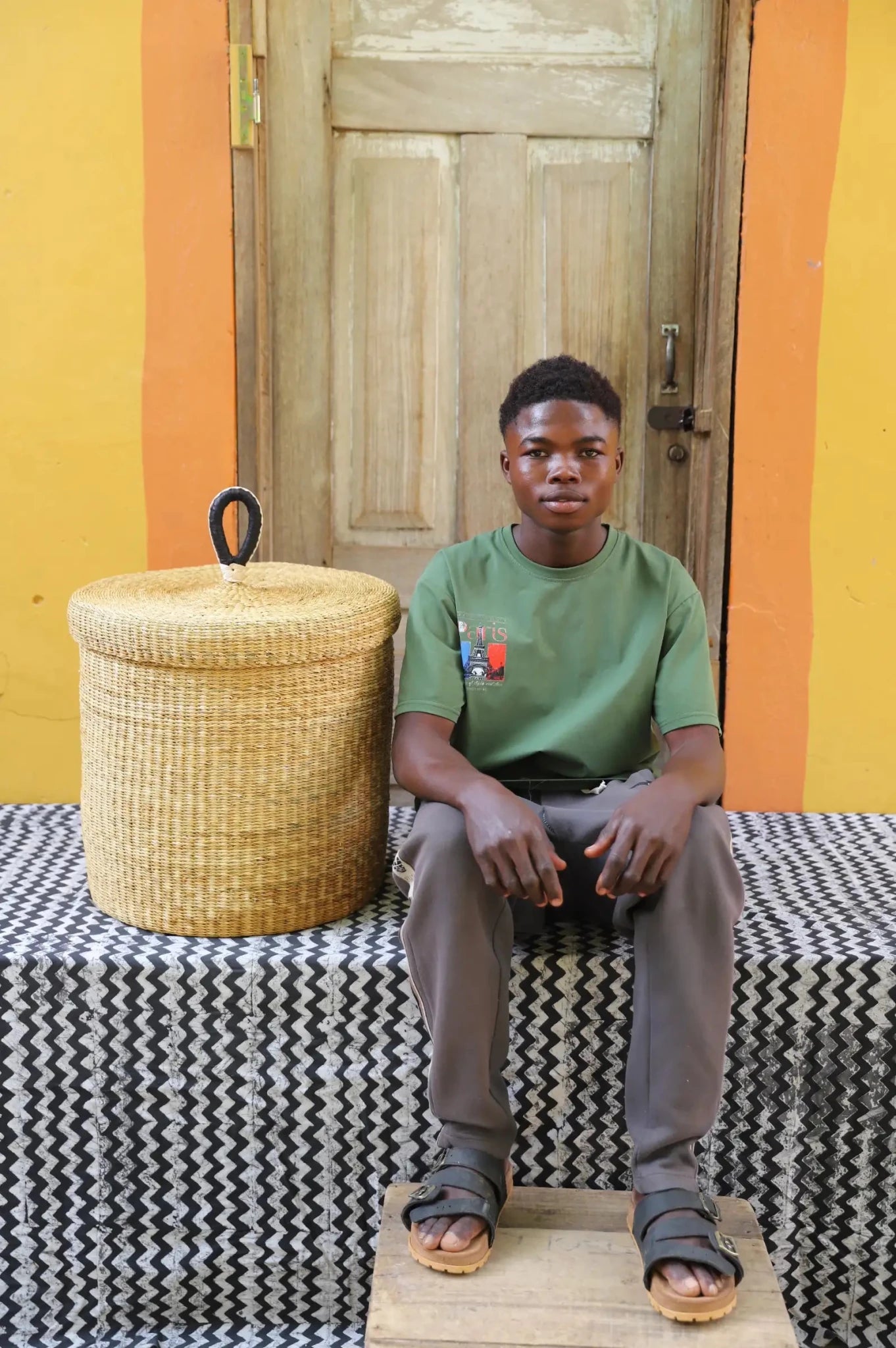 Lidded Laundry Basket (Medium) by The Baba Tree. Handwoven elephant grass with leather handle. Premium Bolgatanga artisan decor.
