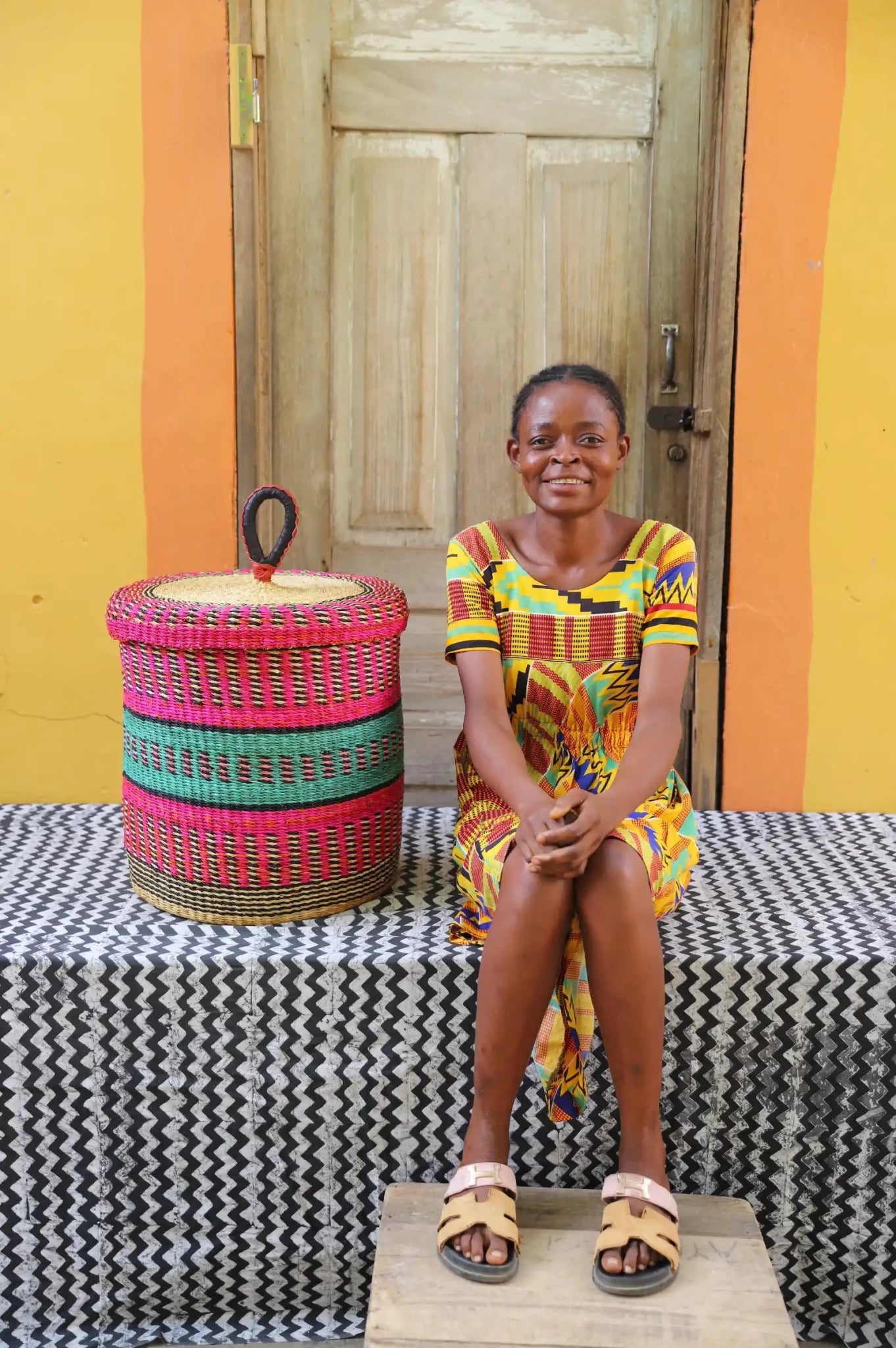 Lidded Laundry Basket (Small) by The Baba Tree. Handwoven elephant grass with leather handle. Premium Bolgatanga artisan decor.