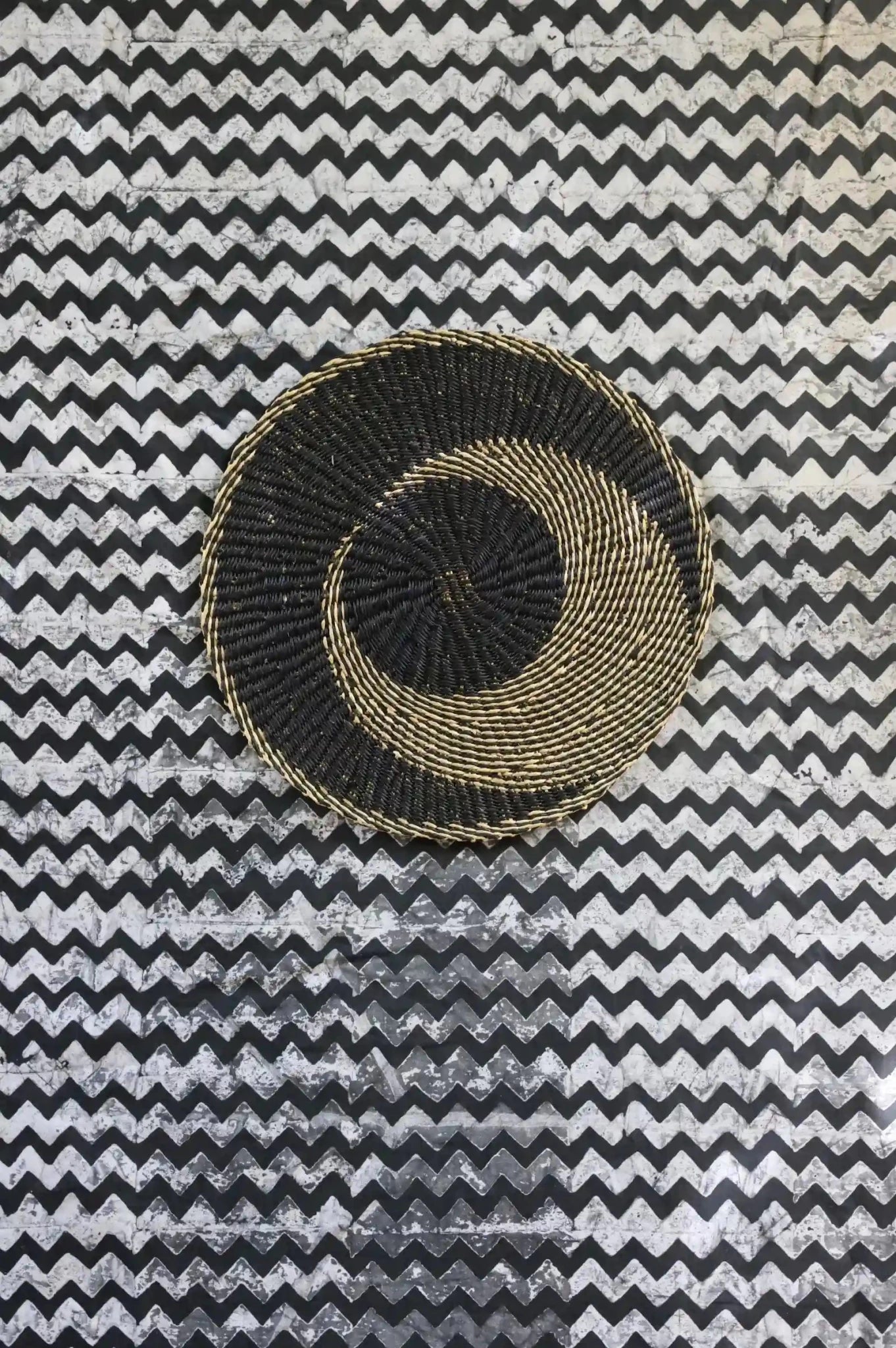 Beautiful woven placemat against a black and white table cloth