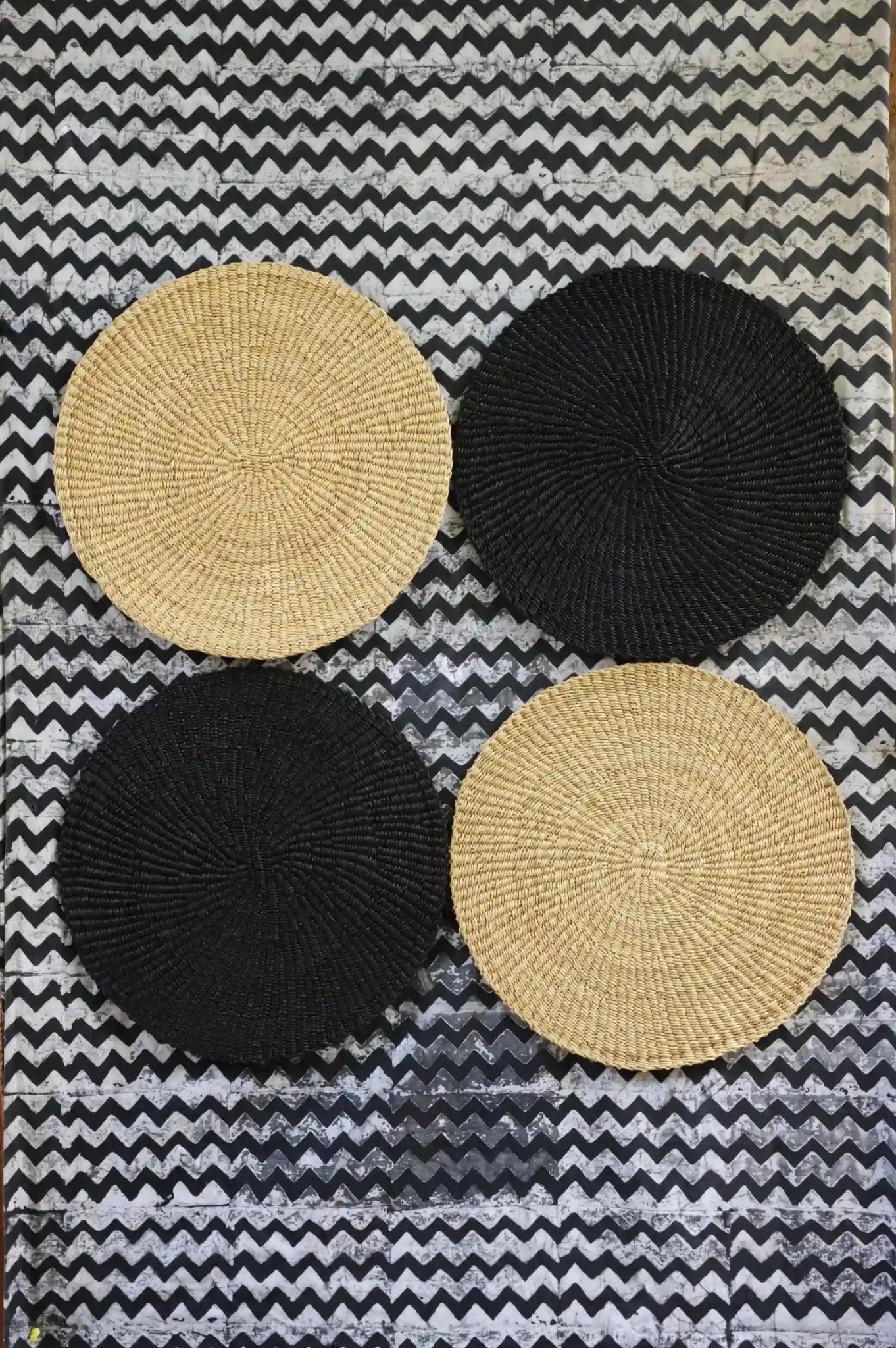 Beautiful woven placemats against a black and white table cloth