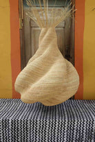 Woven basket on a striped surface with a colorful wall background