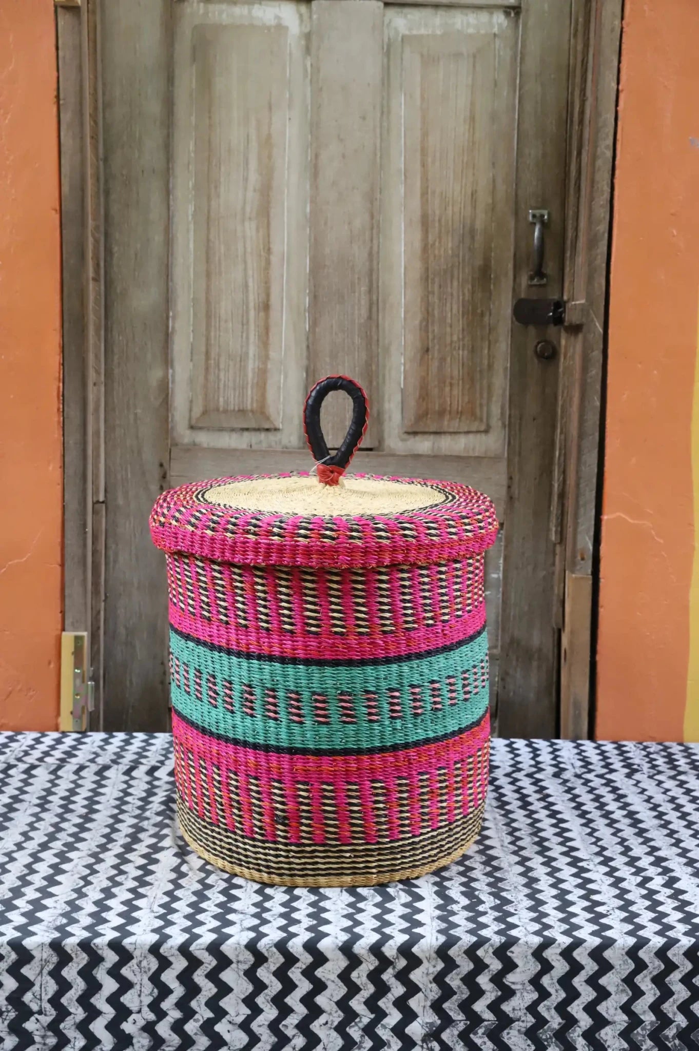 Lidded Laundry Basket  (Small) by The Baba Tree. Handwoven elephant grass with leather handle. Premium Bolgatanga artisan decor.