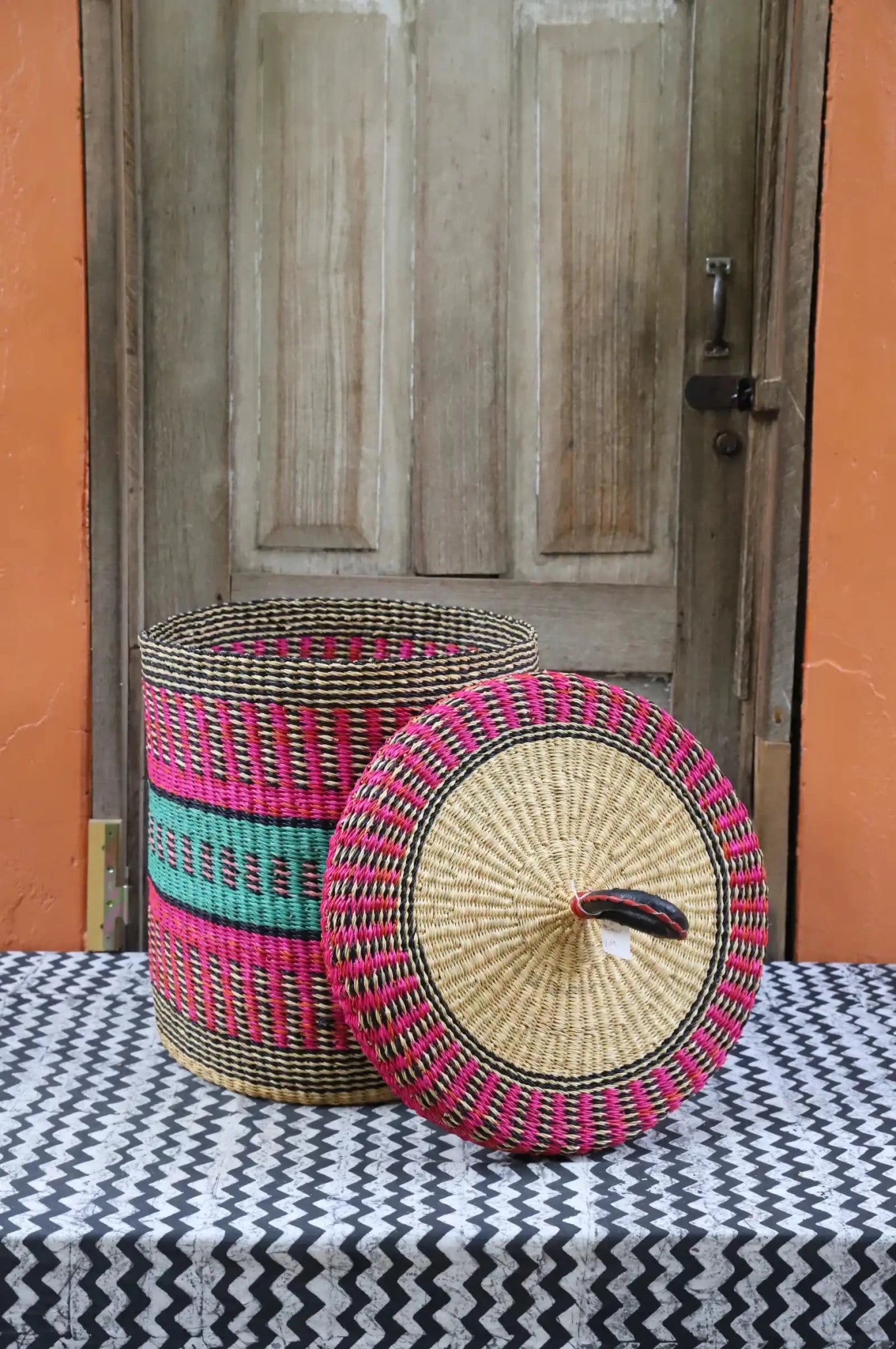 Lidded Laundry Basket  (Small) by The Baba Tree. Handwoven elephant grass with leather handle. Premium Bolgatanga artisan decor.