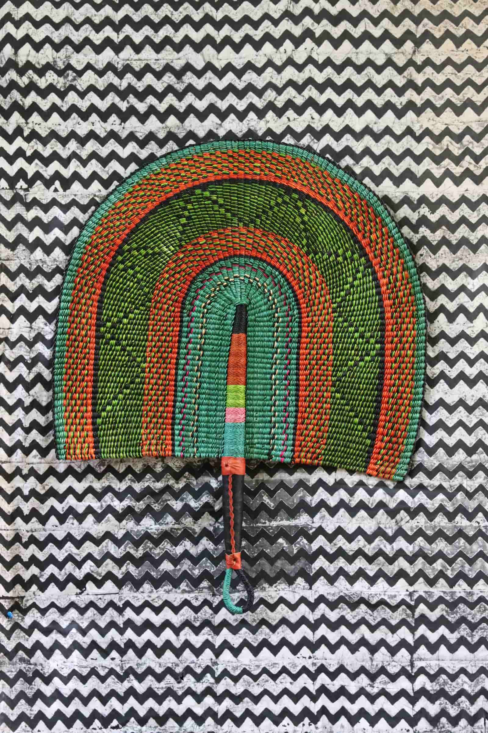 The Baba Tree Bolga Original Fan: Handwoven architectural wall art with intricate weave and premium leather handle.