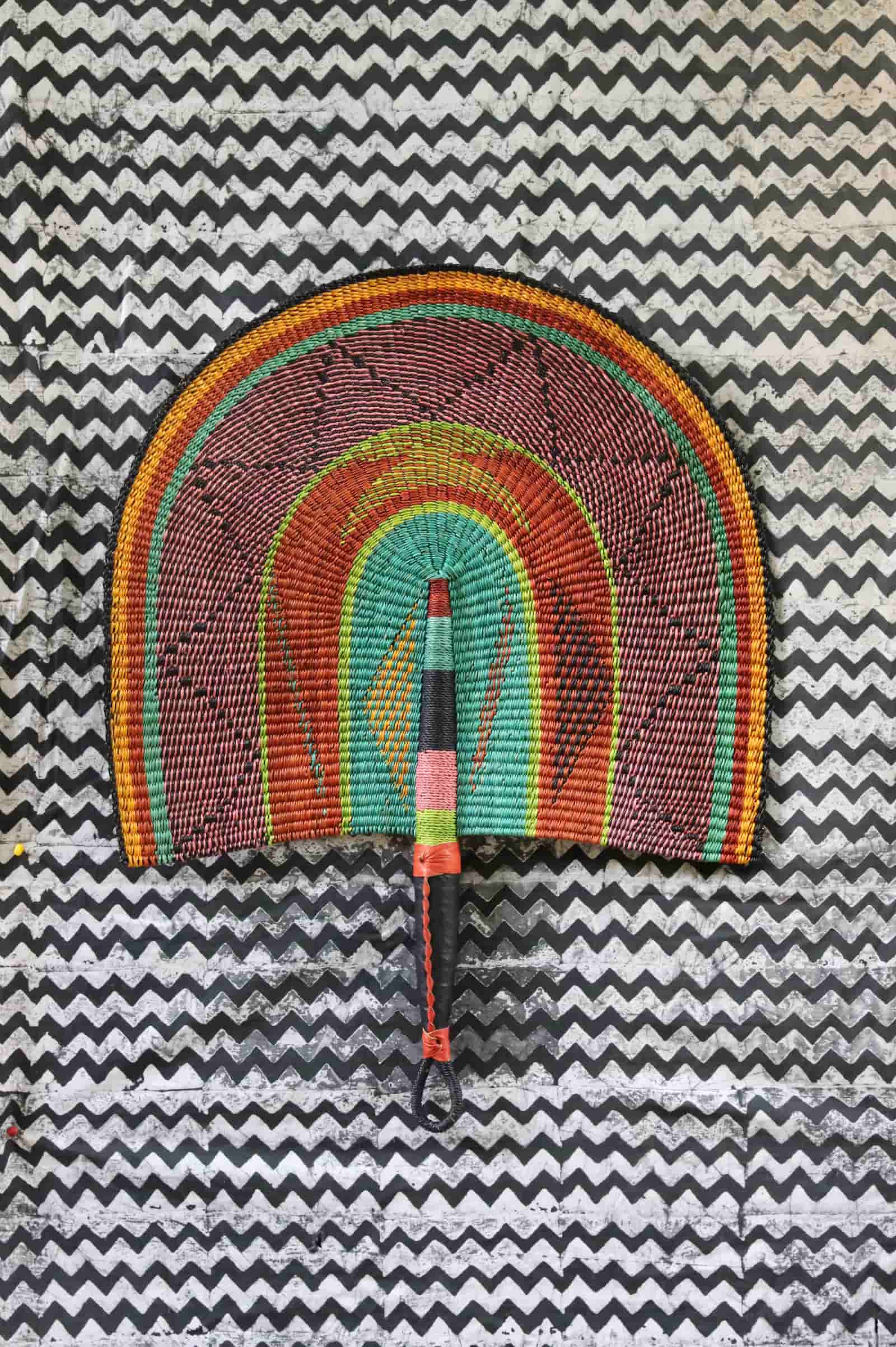 The Baba Tree Bolga Original Fan: Handwoven architectural wall art with intricate weave and premium leather handle.
