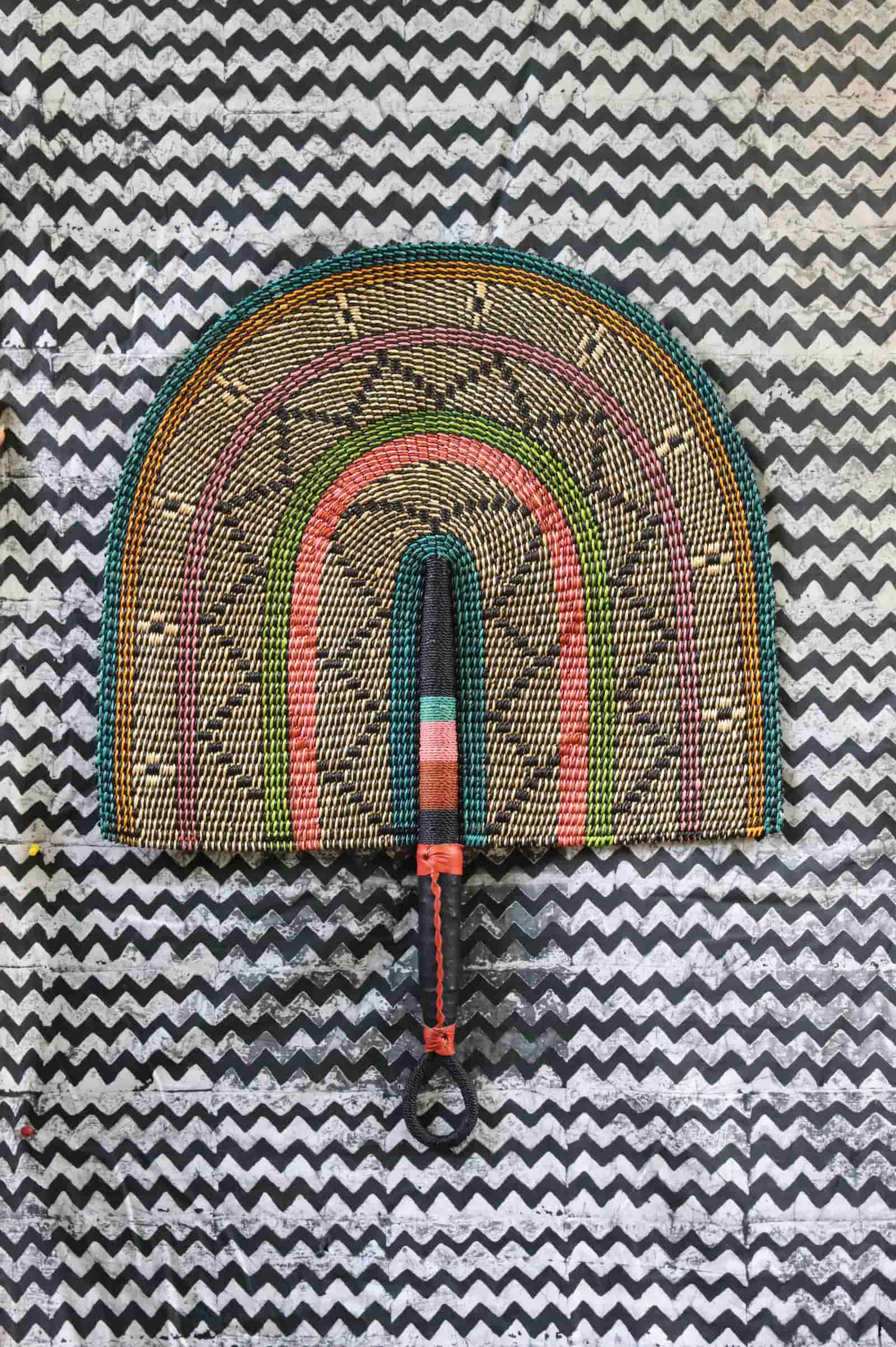 The Baba Tree Bolga Original Fan: Handwoven architectural wall art with intricate weave and premium leather handle.