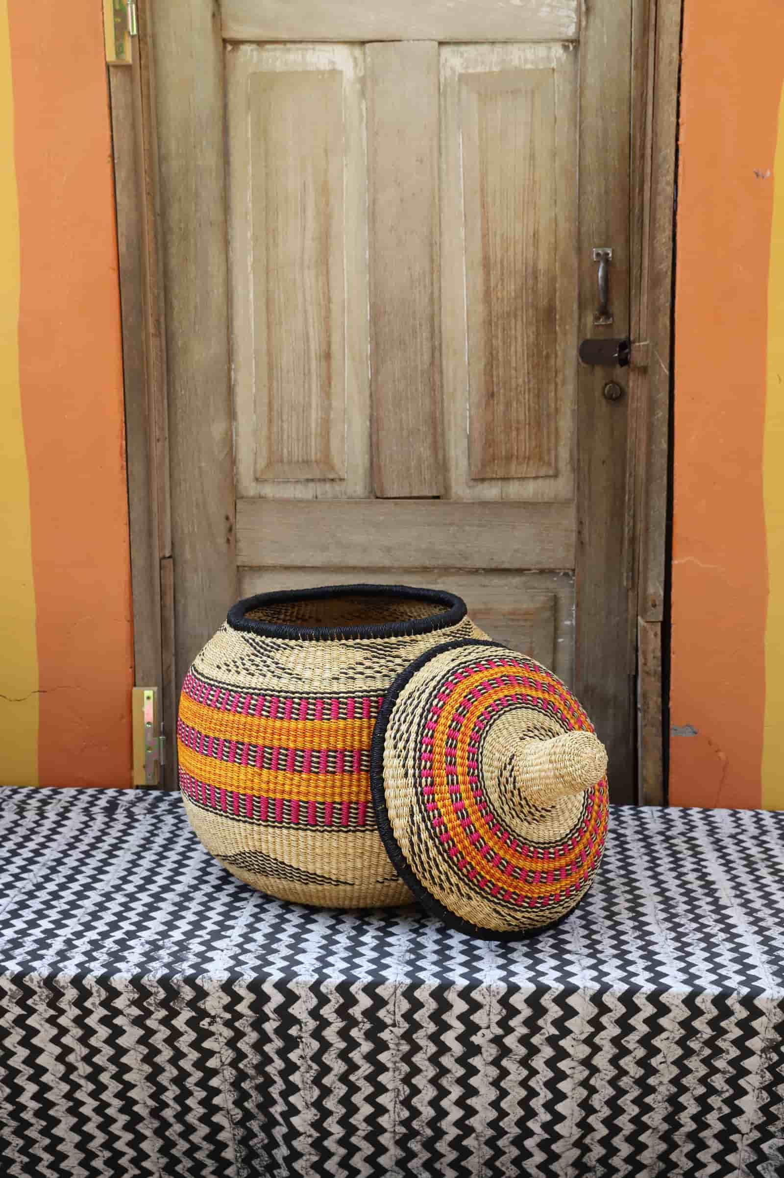 Large Orbit storage basket in natural straw with orange and pink stripe bands, lid off