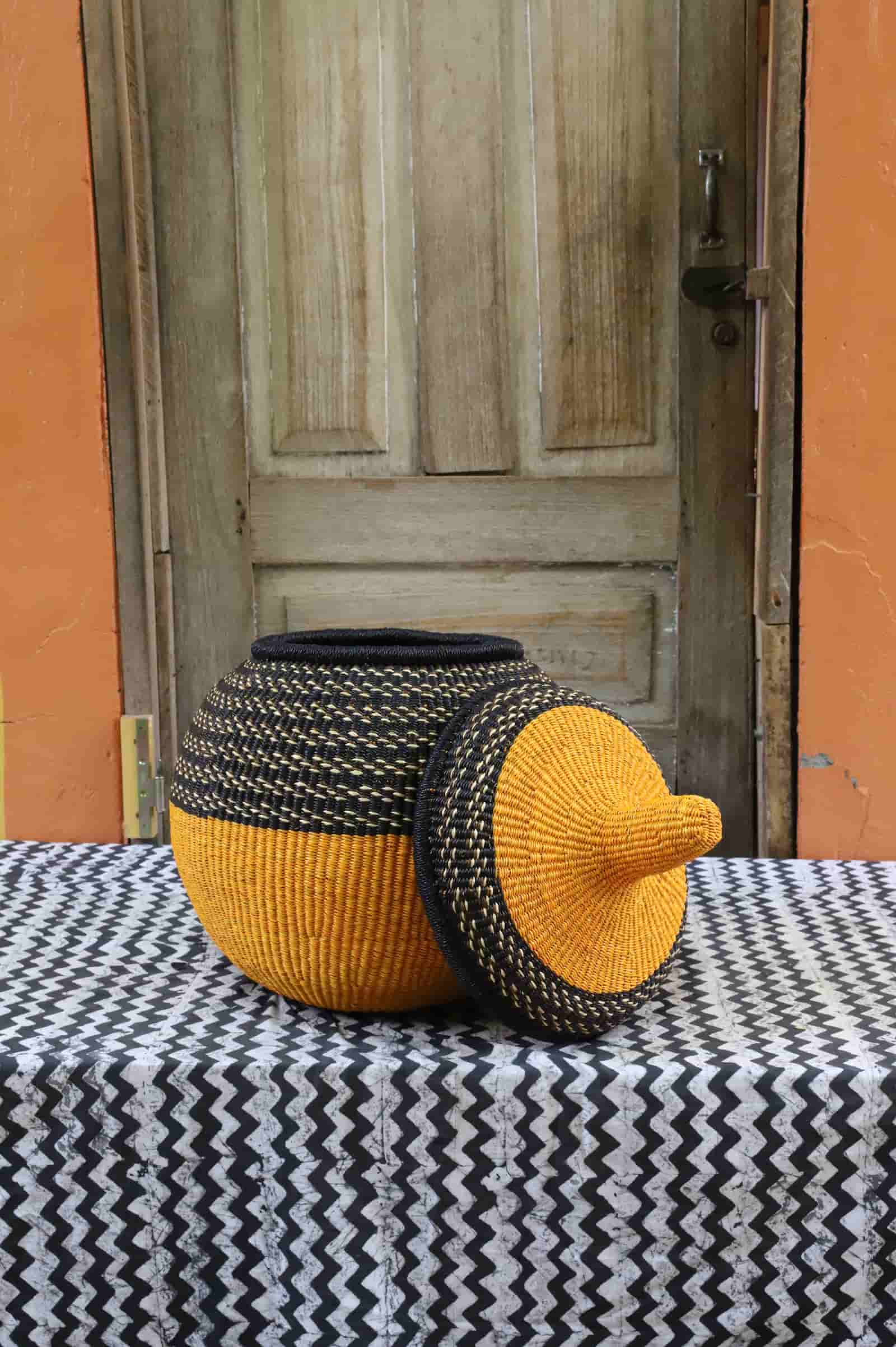 Large Orbit storage basket in yellow and black stripe, shown on its side with lid off