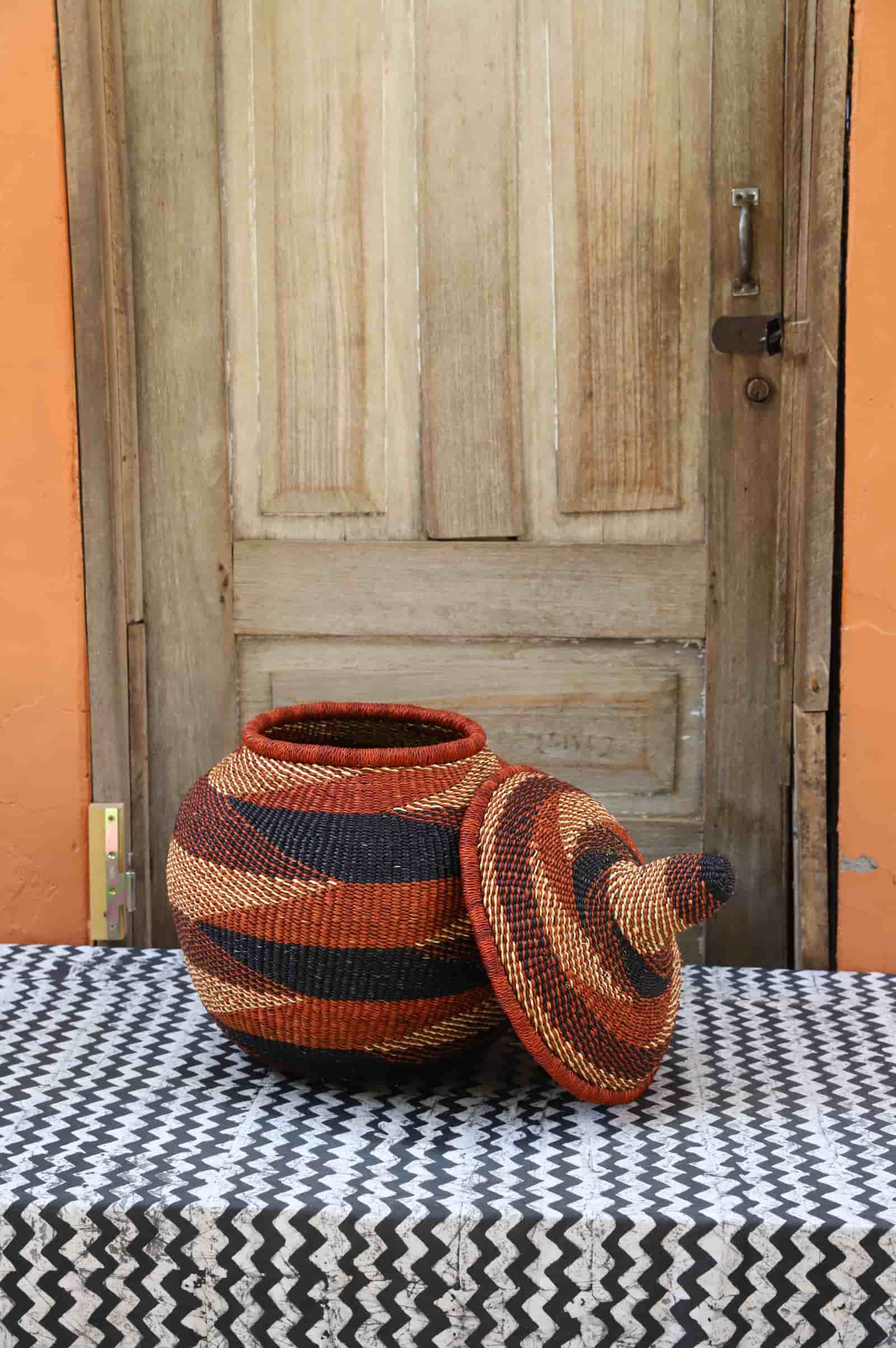 Medium Orbit storage basket in rust and black diagonal stripe, lid off showing interior