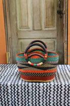 Colorful woven basket on a table with a wooden door in the background