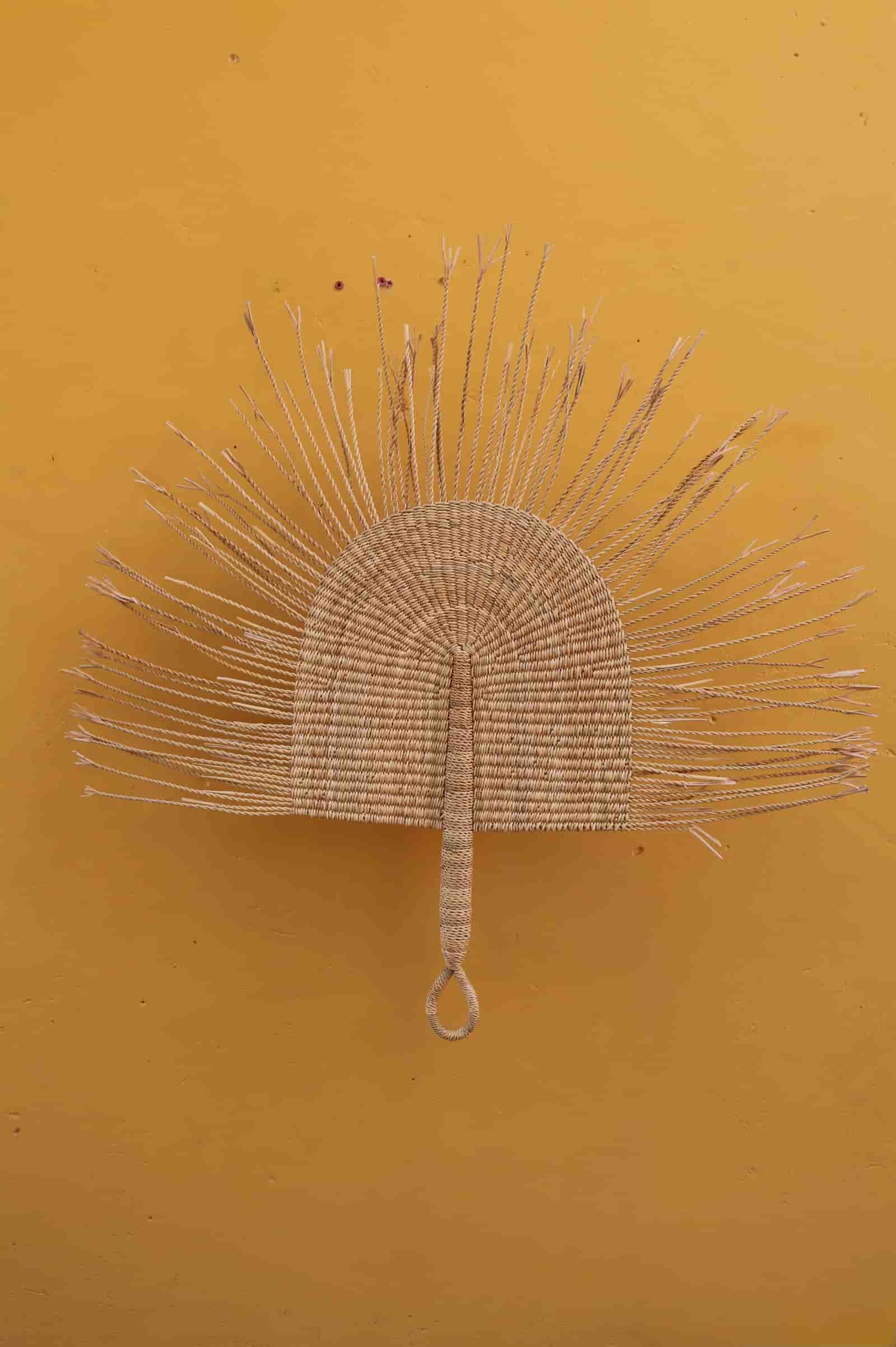 Decorative fan on a yellow background