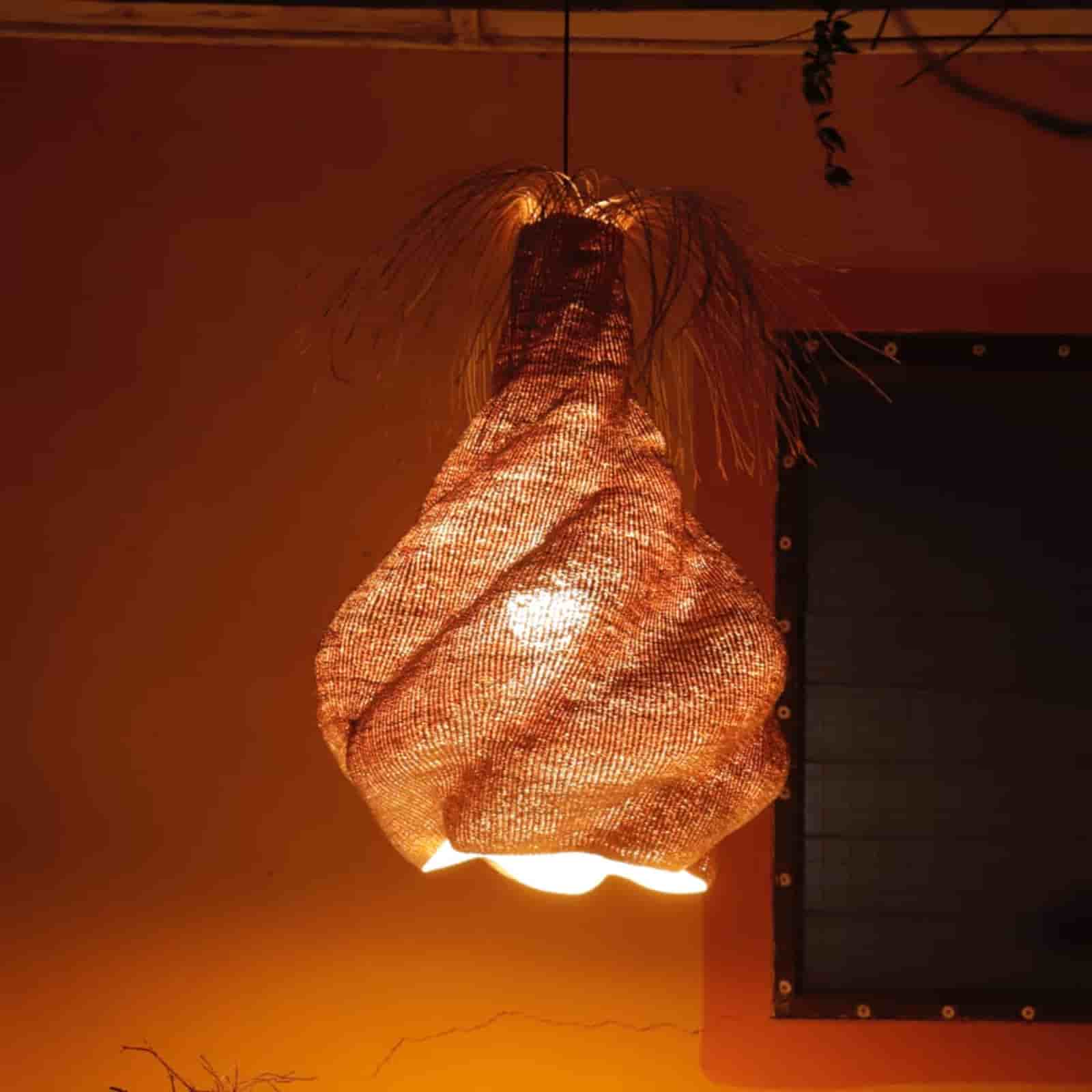 Woven light fixture hanging against a warm-toned background