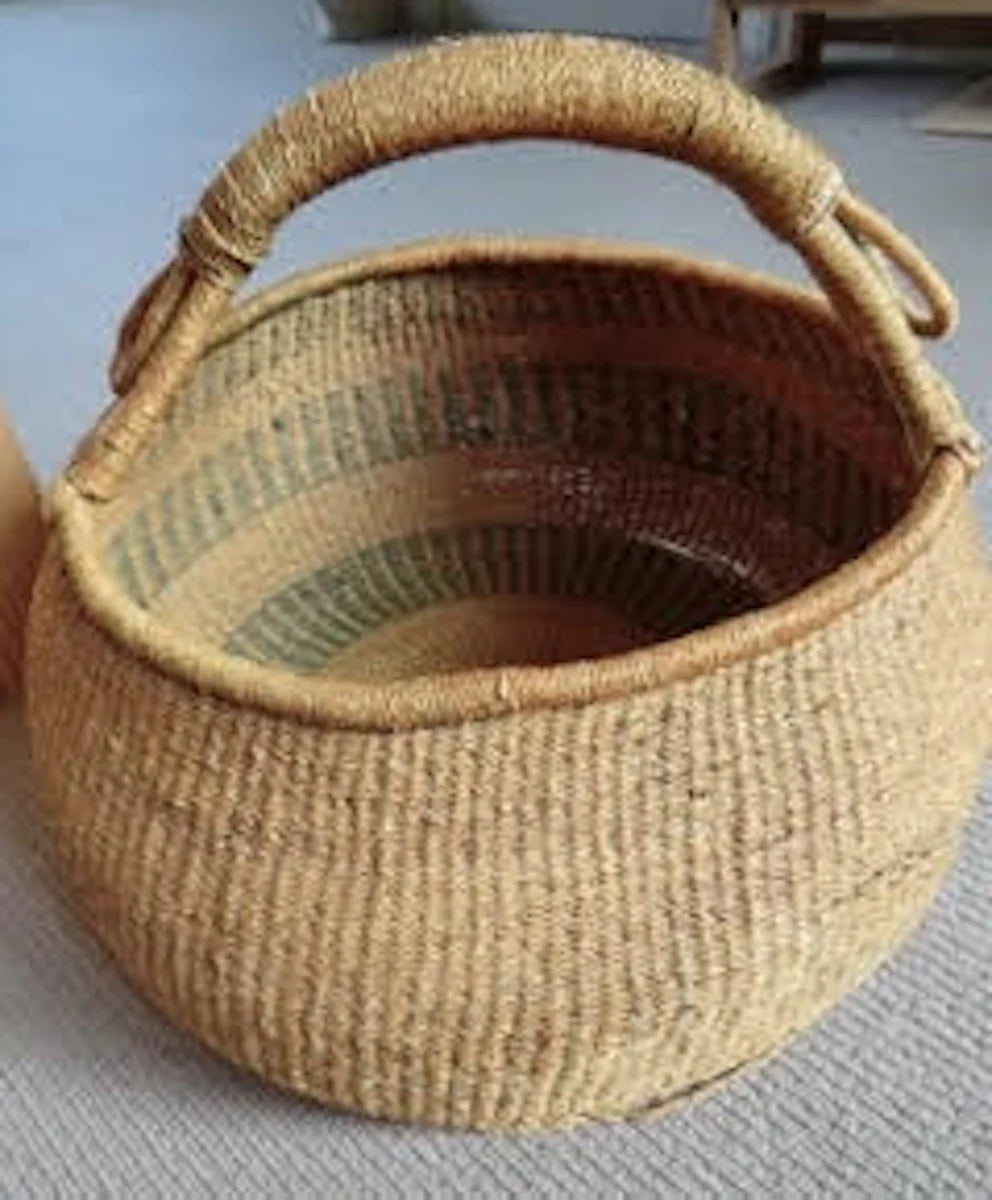 Traditional Bolga basket purchased in Bolgatanga, Ghana, in the 1960s, showing its woven structure and handles after more than sixty years.