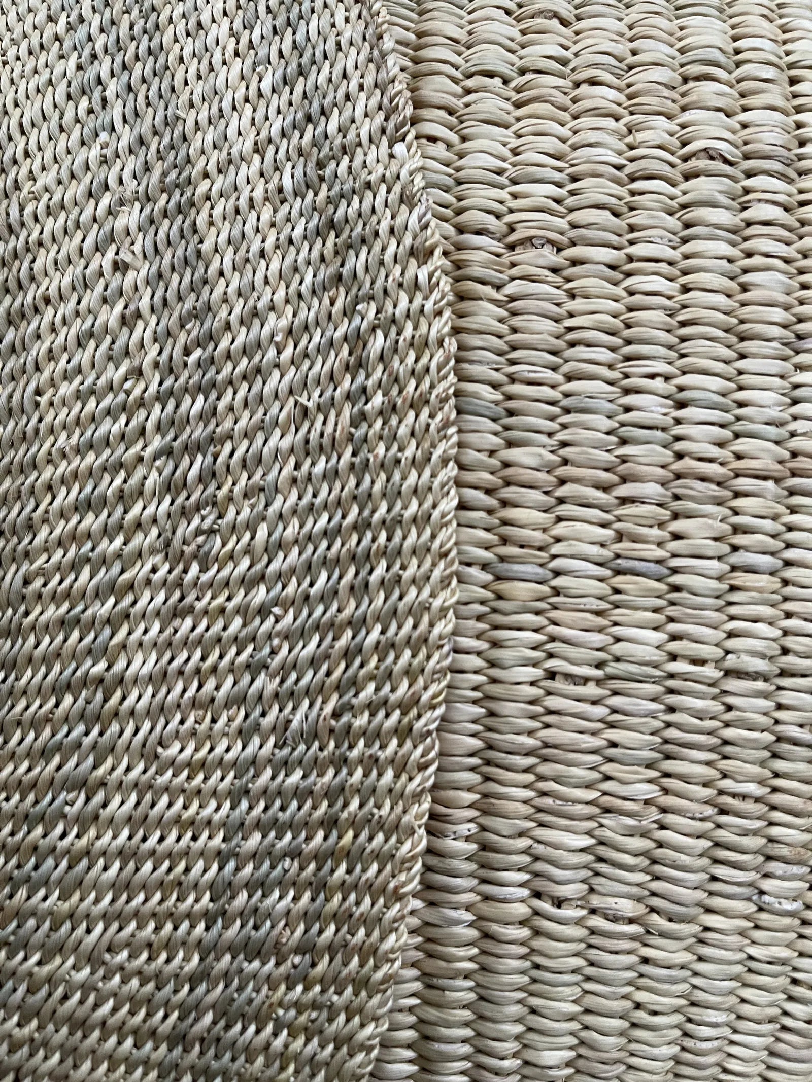 Close detail of fine straw weaving beside the larger weave of a natural-coloured basket.
