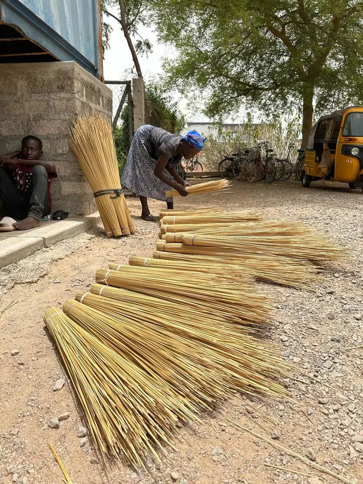 Bundles of straw laid out on the ground at the Baba Tree compound