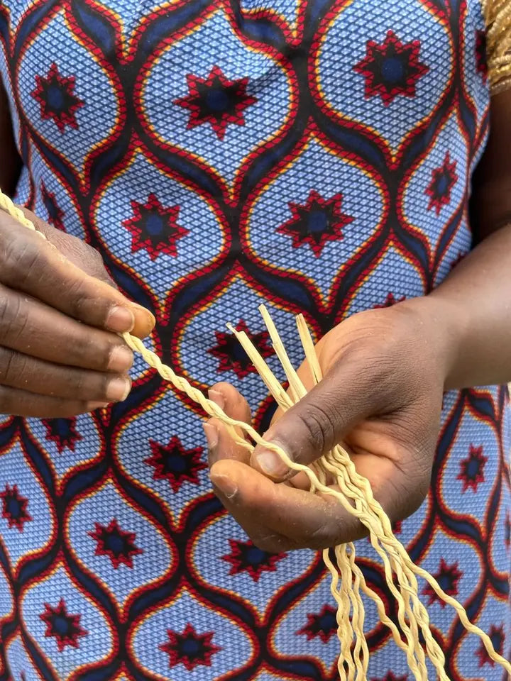 Close view of hands unravelling rolled straw