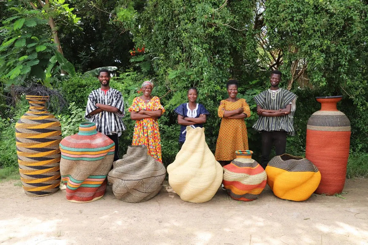 Baba Tree basket makers standing with large sculptural baskets