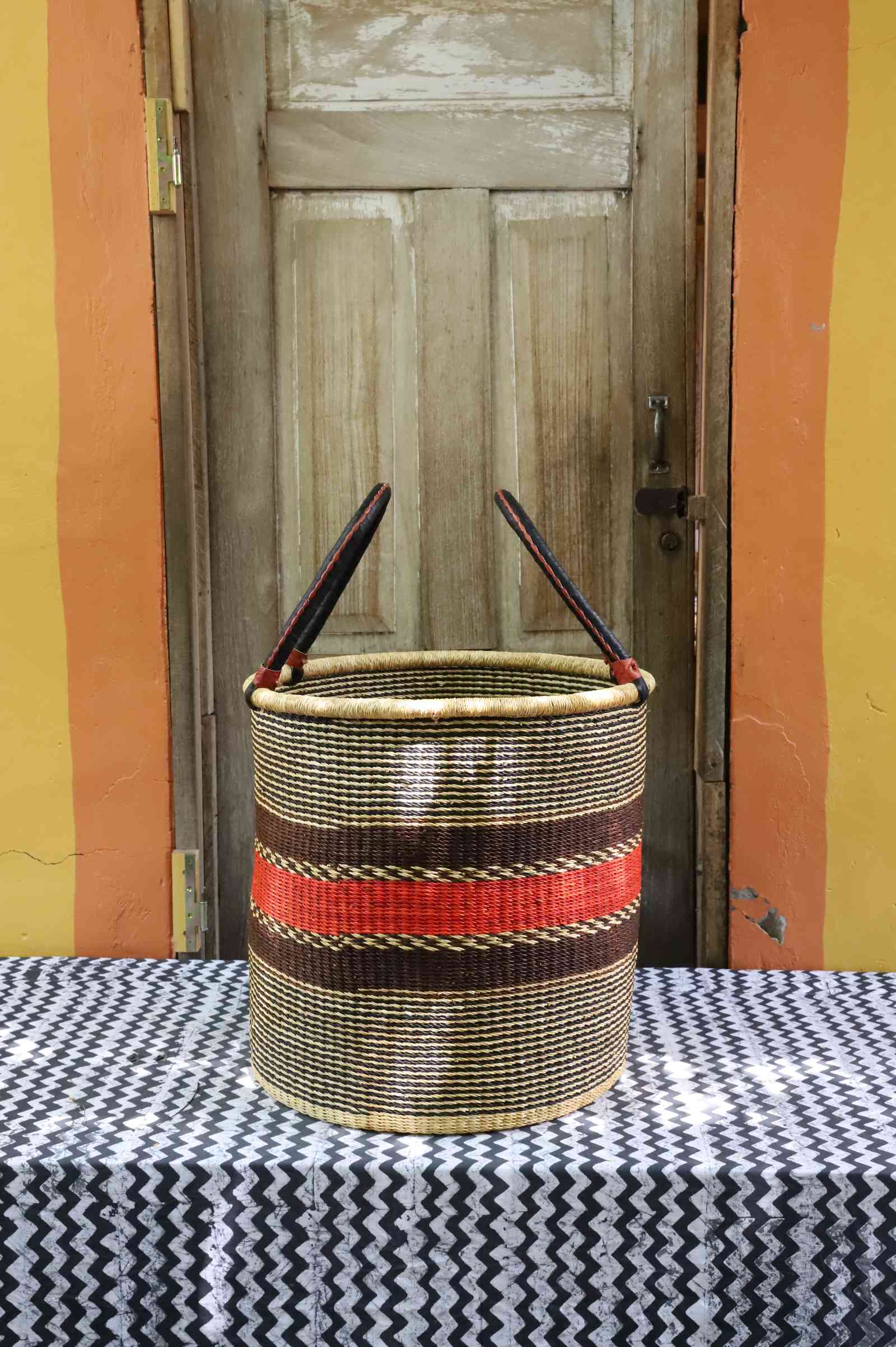 Large open laundry basket handwoven in elephant grass, 51 cm wide and 51 cm tall.