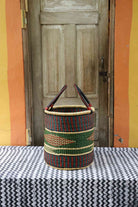Handwoven Bolga laundry basket in elephant grass with an open top and hand-coiled form.