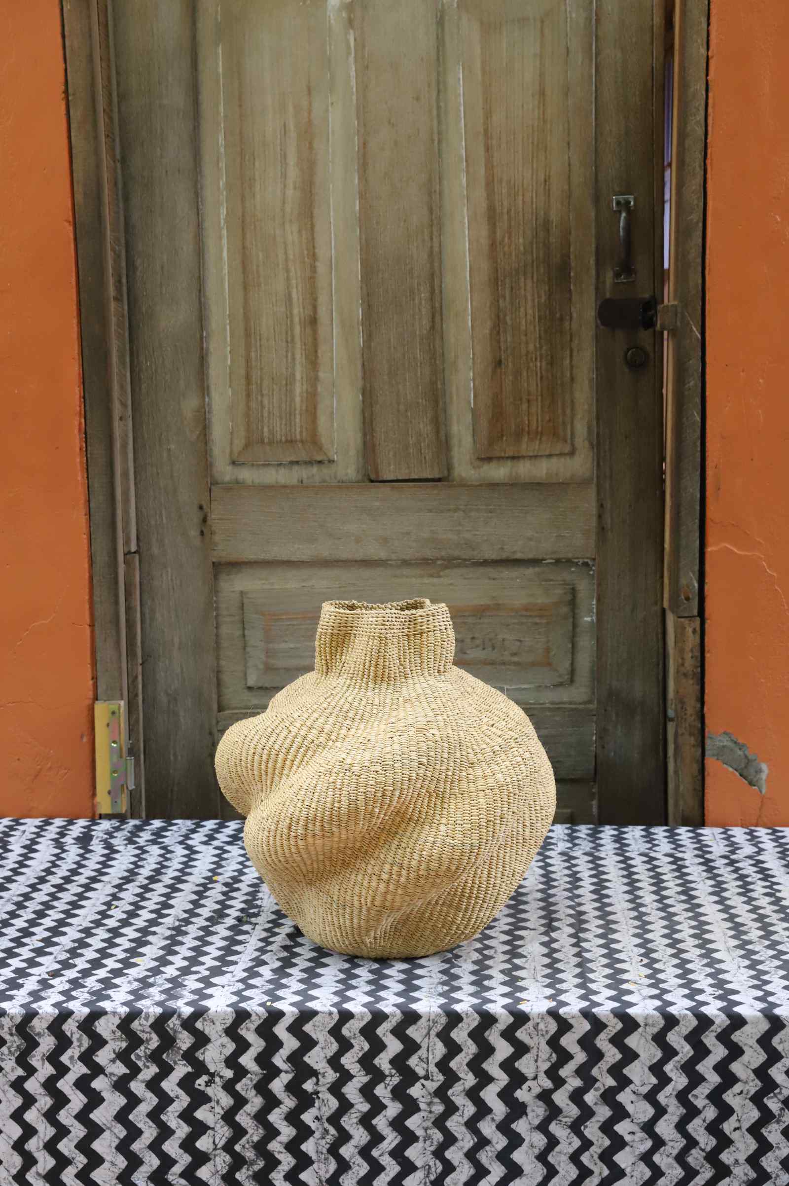 Handwoven Bolga art basket in a lobed sculpted form, all natural straw with a tight even weave.