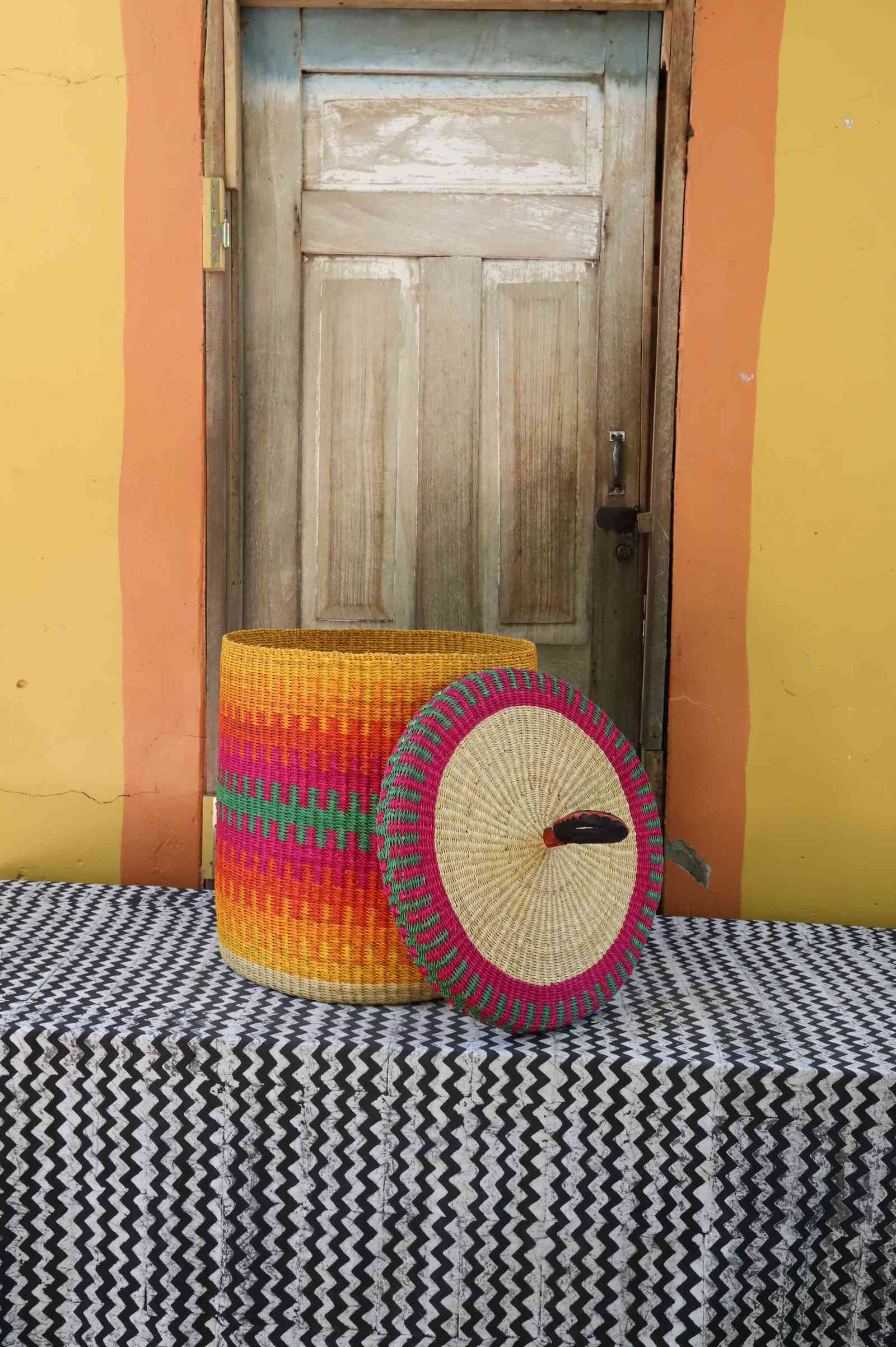 Handwoven Bolga laundry basket with lid removed, fine multicolour striped body with matching lid.