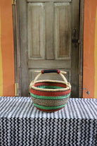 Medium round Bolga basket handwoven in elephant grass, standing 28 cm tall.