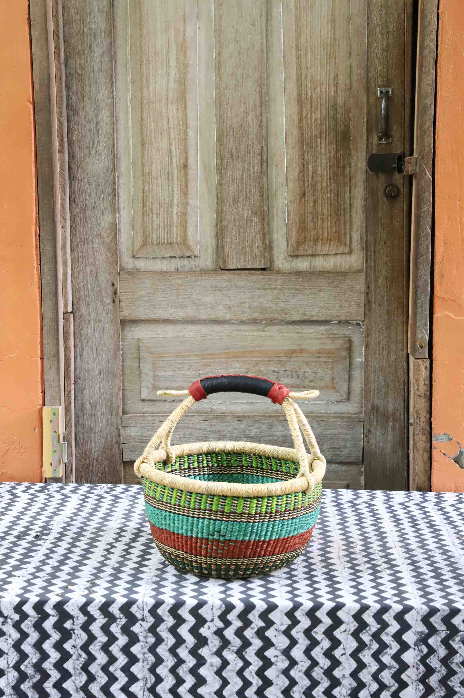 Handwoven Bolga shopping basket in elephant grass, round in form with two handles.