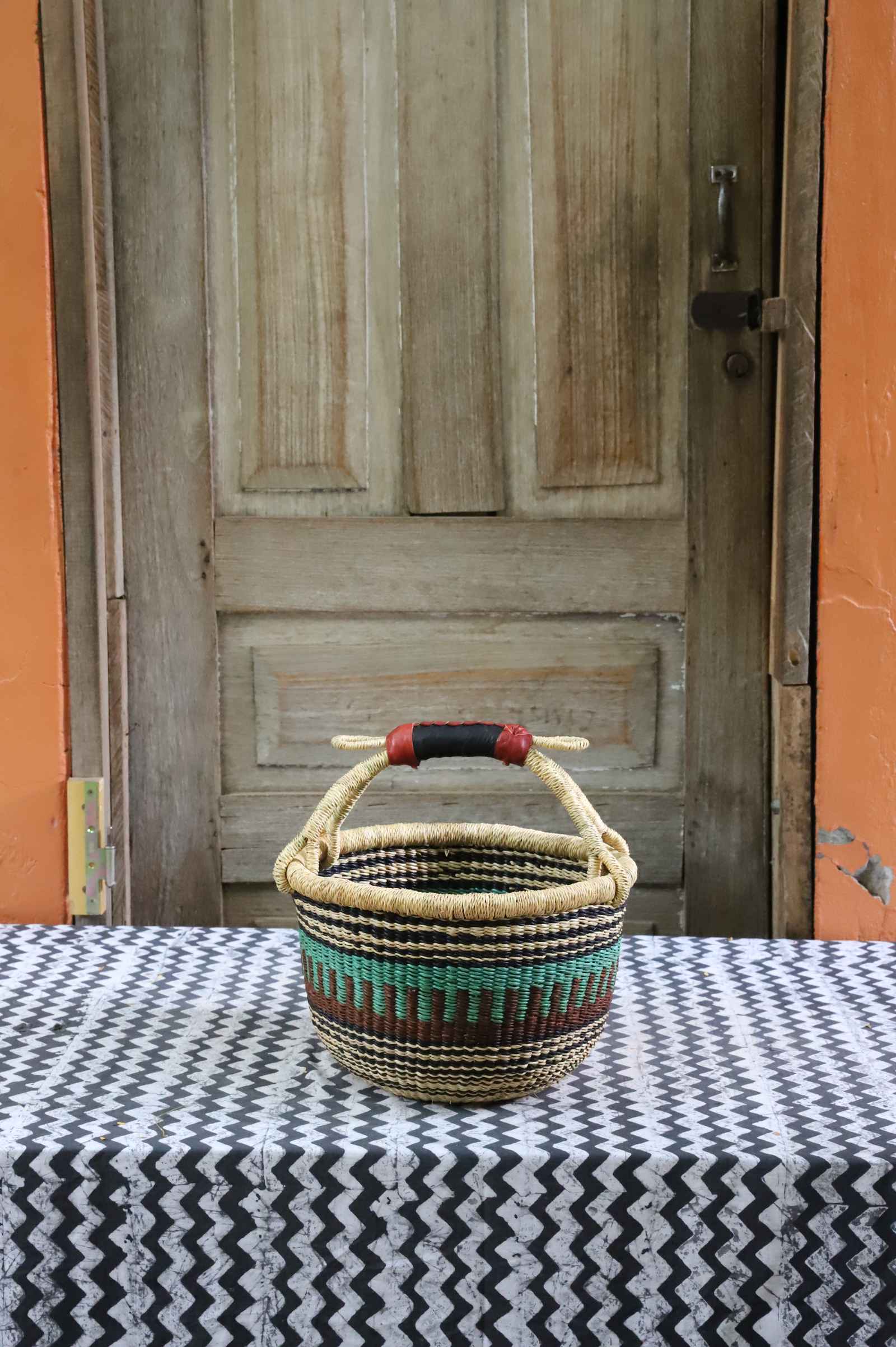Round shopping basket, a handwoven Bolga basket in elephant grass with two handles.