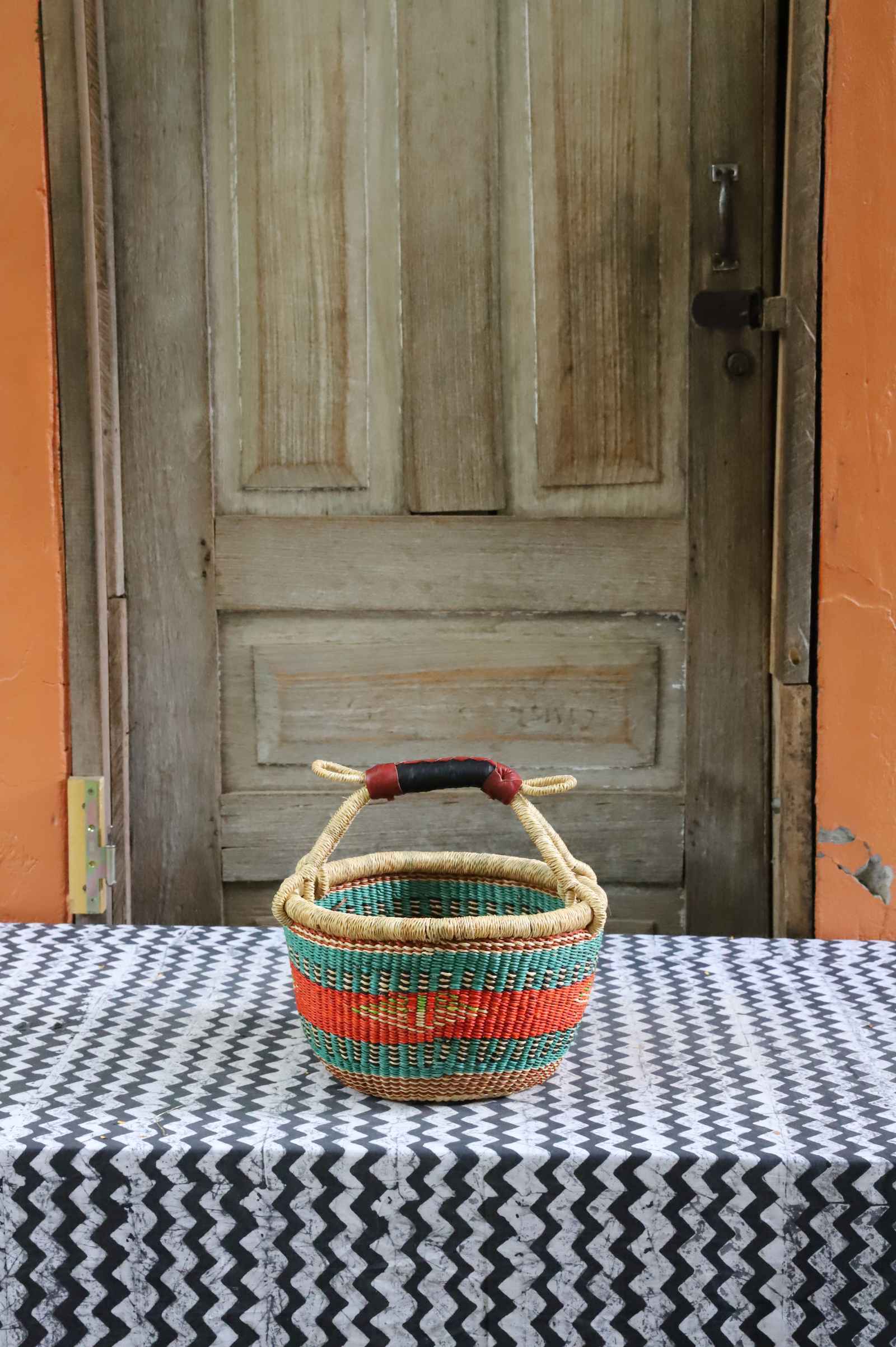 Handwoven African basket in elephant grass, round shopping form with paired handles.